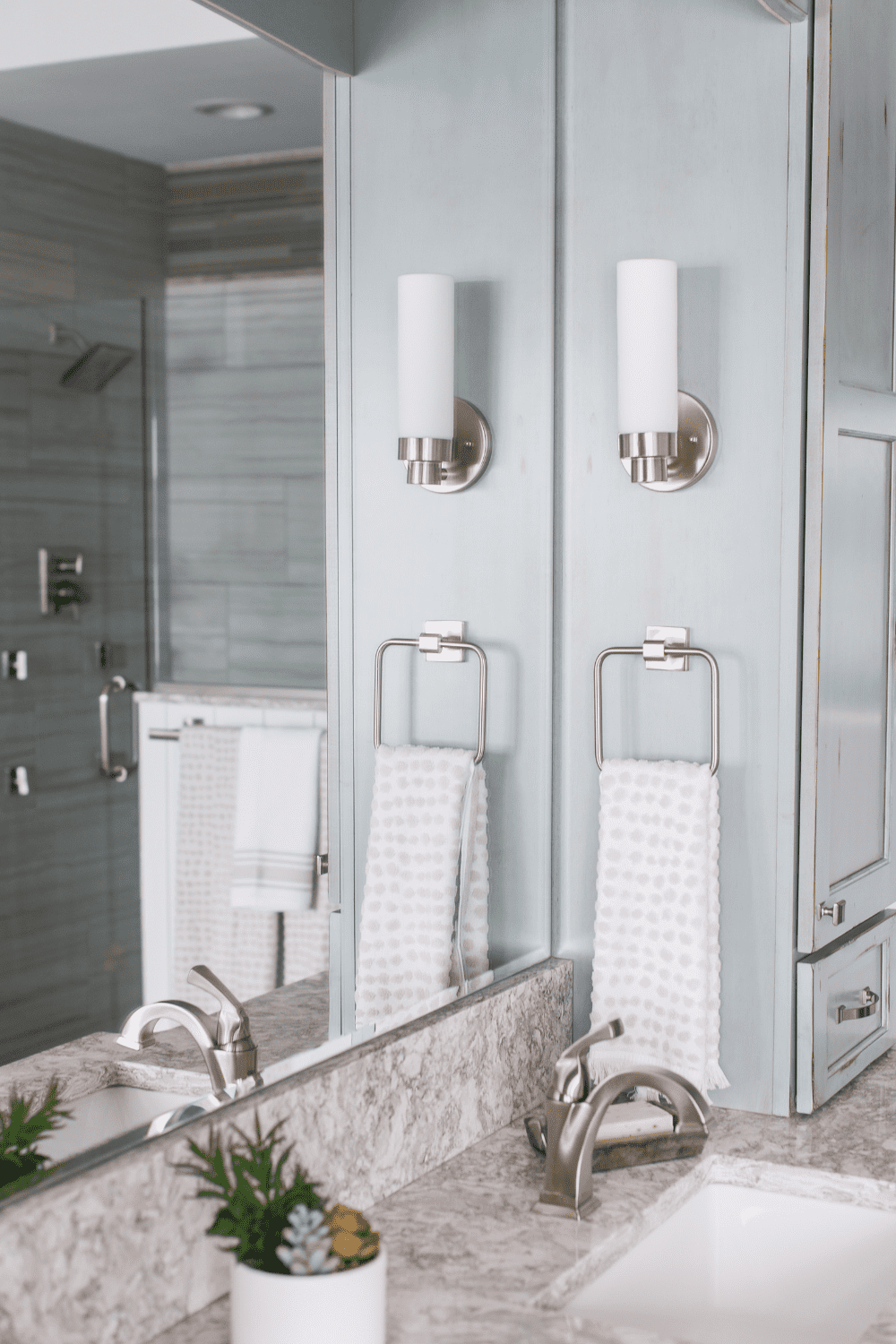 Nicholas Design Build | A master bathroom with a mirror and a sink.