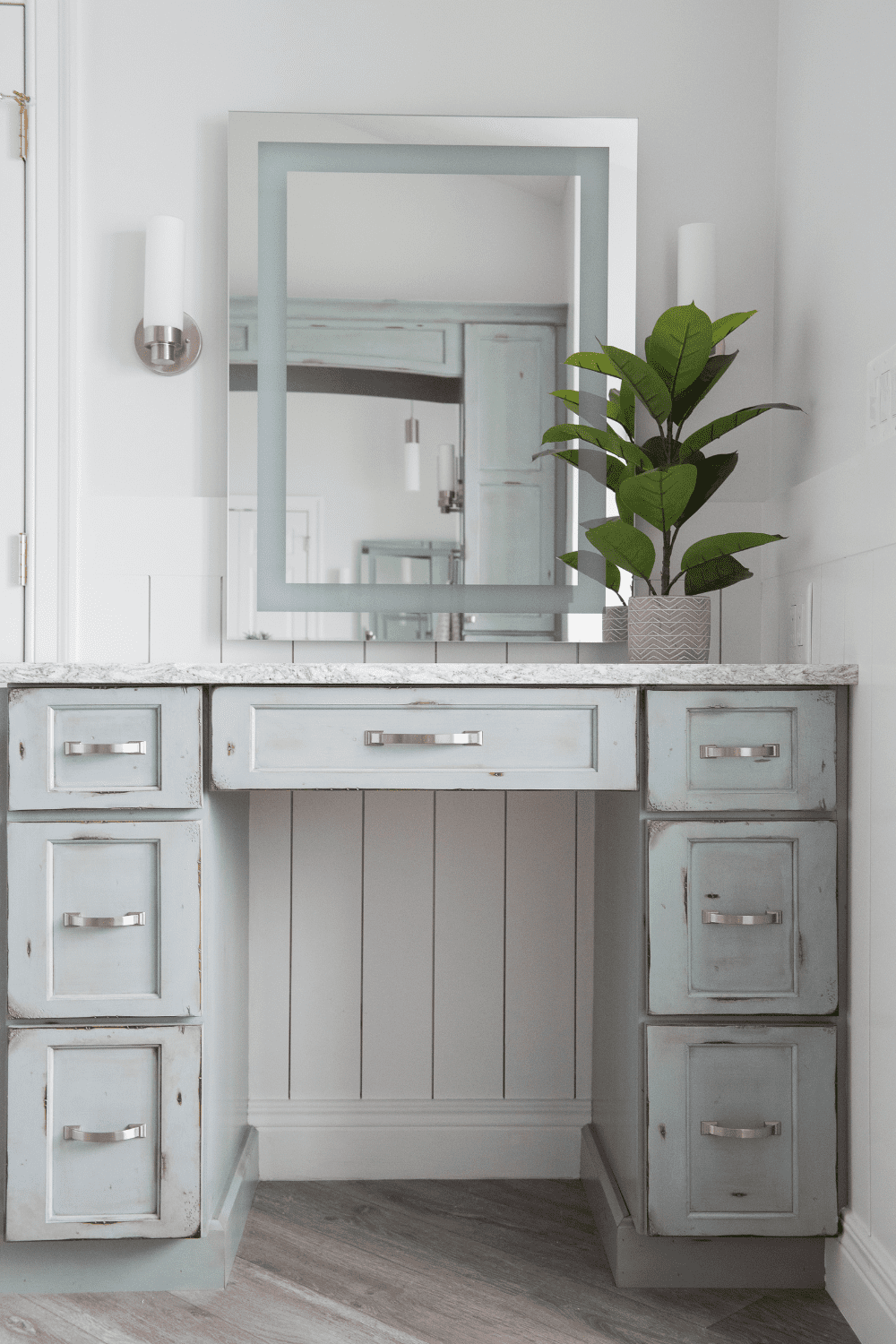 Nicholas Design Build | A master bathroom vanity with a mirror and drawers.