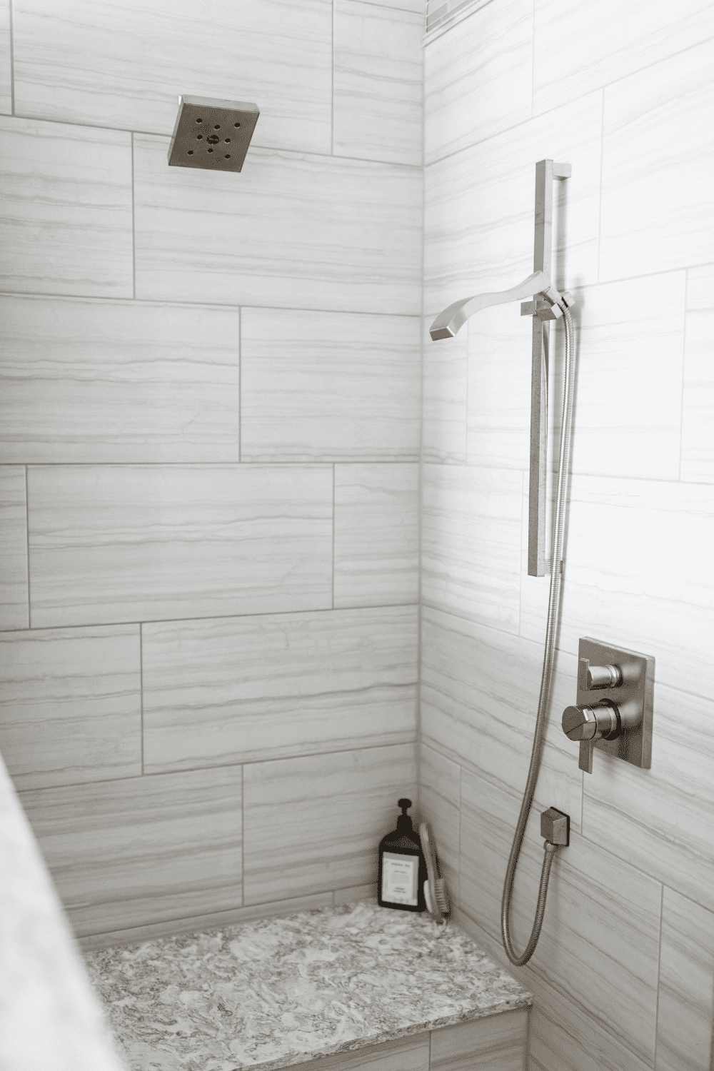 Nicholas Design Build | A black and white photo of a master bathroom with a shower.
