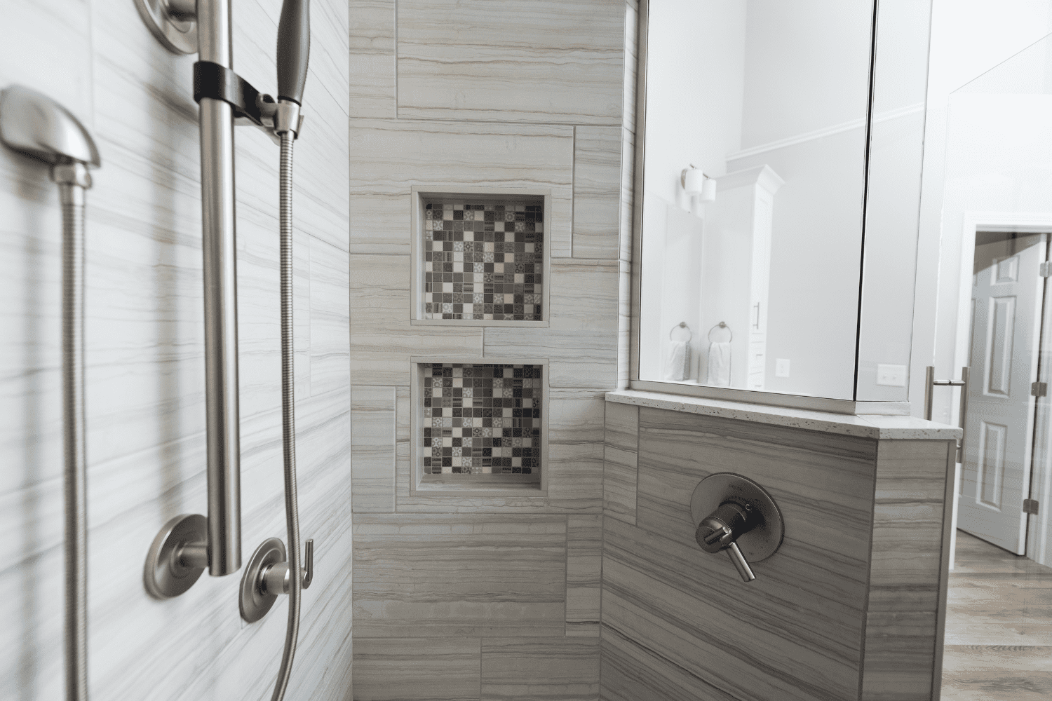 Nicholas Design Build | A black and white photo of a bathroom remodel featuring a shower.