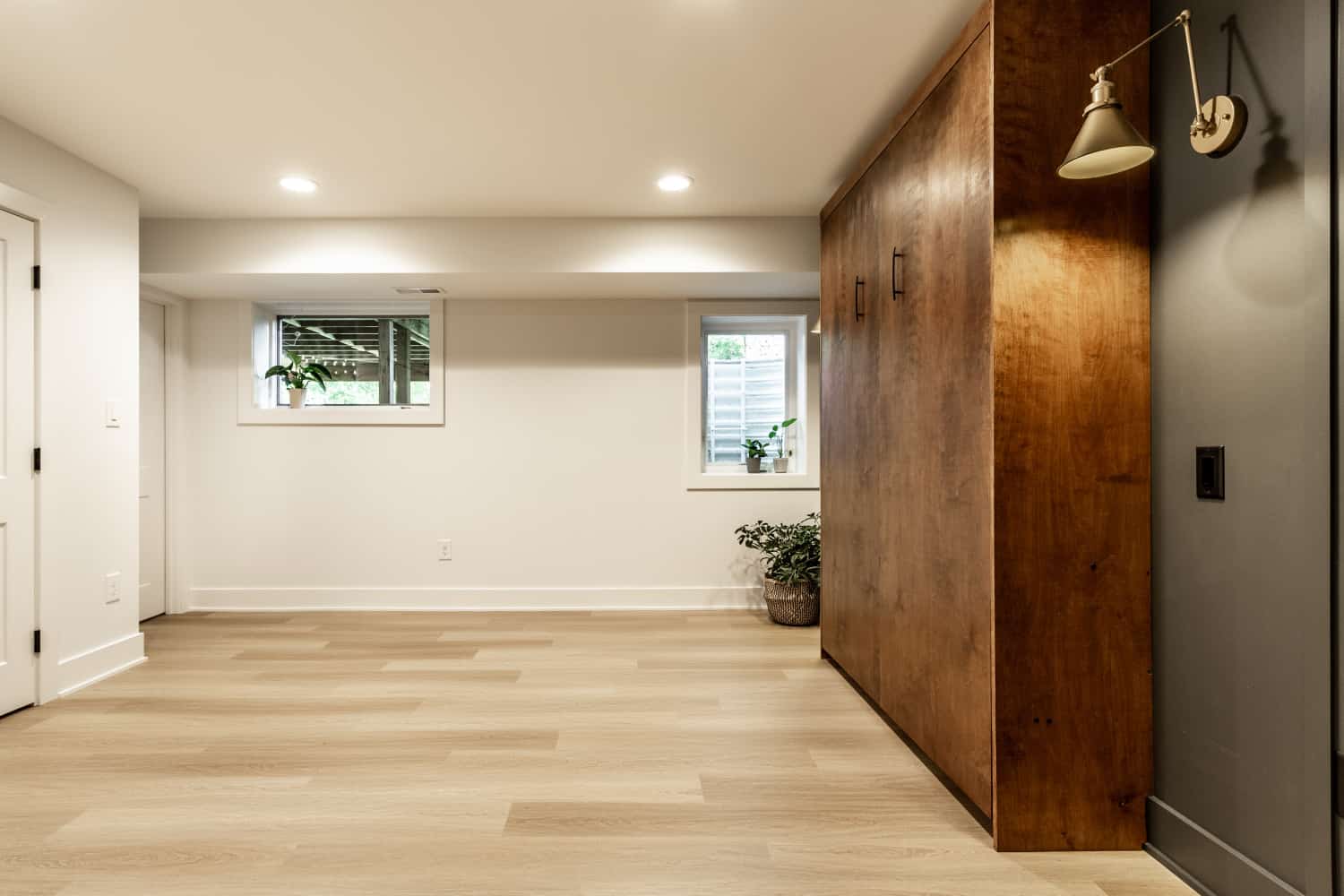 Nicholas Design Build | Remodel: A renovated room with wood floors and a wooden door.