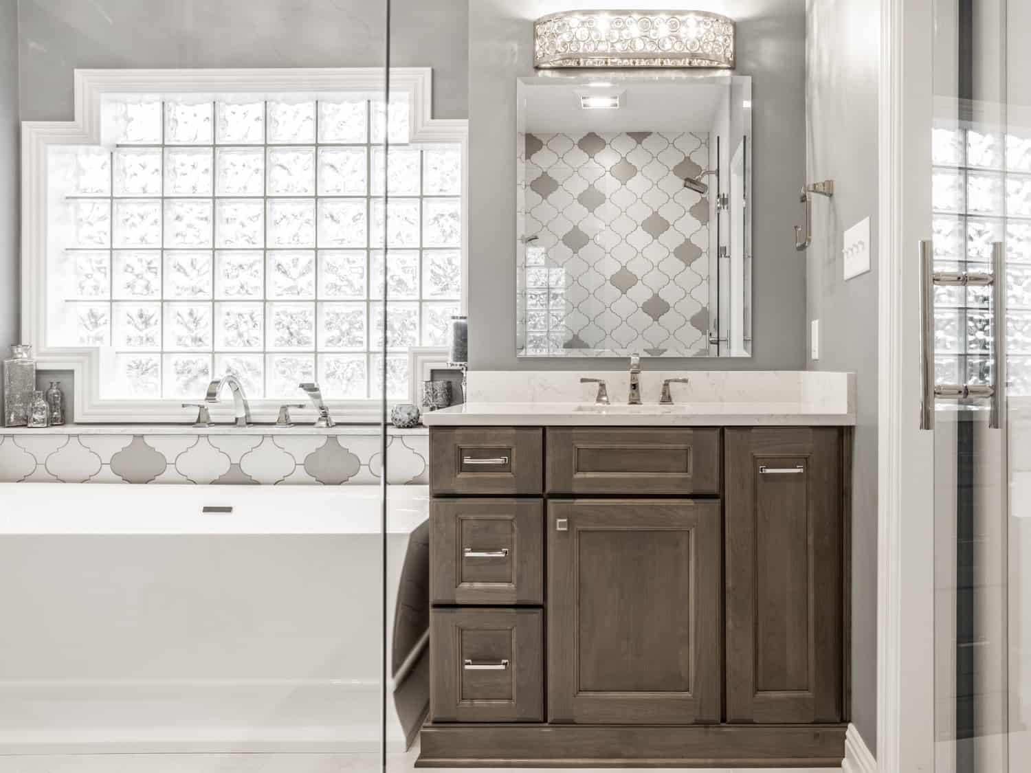 Nicholas Design Build | A gray bathroom with a tub and sink.