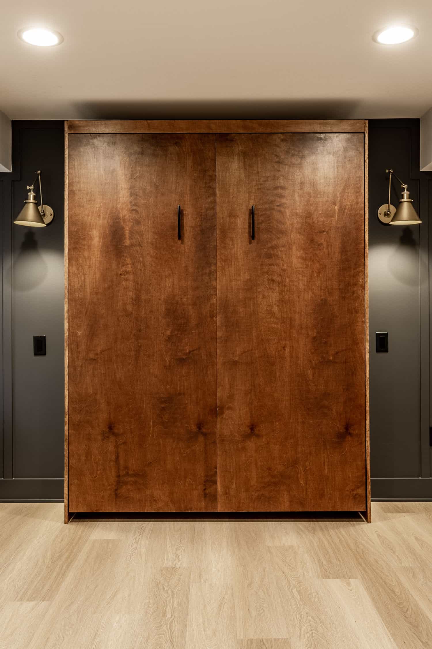 Nicholas Design Build | A remodeled wooden closet in a dark basement.