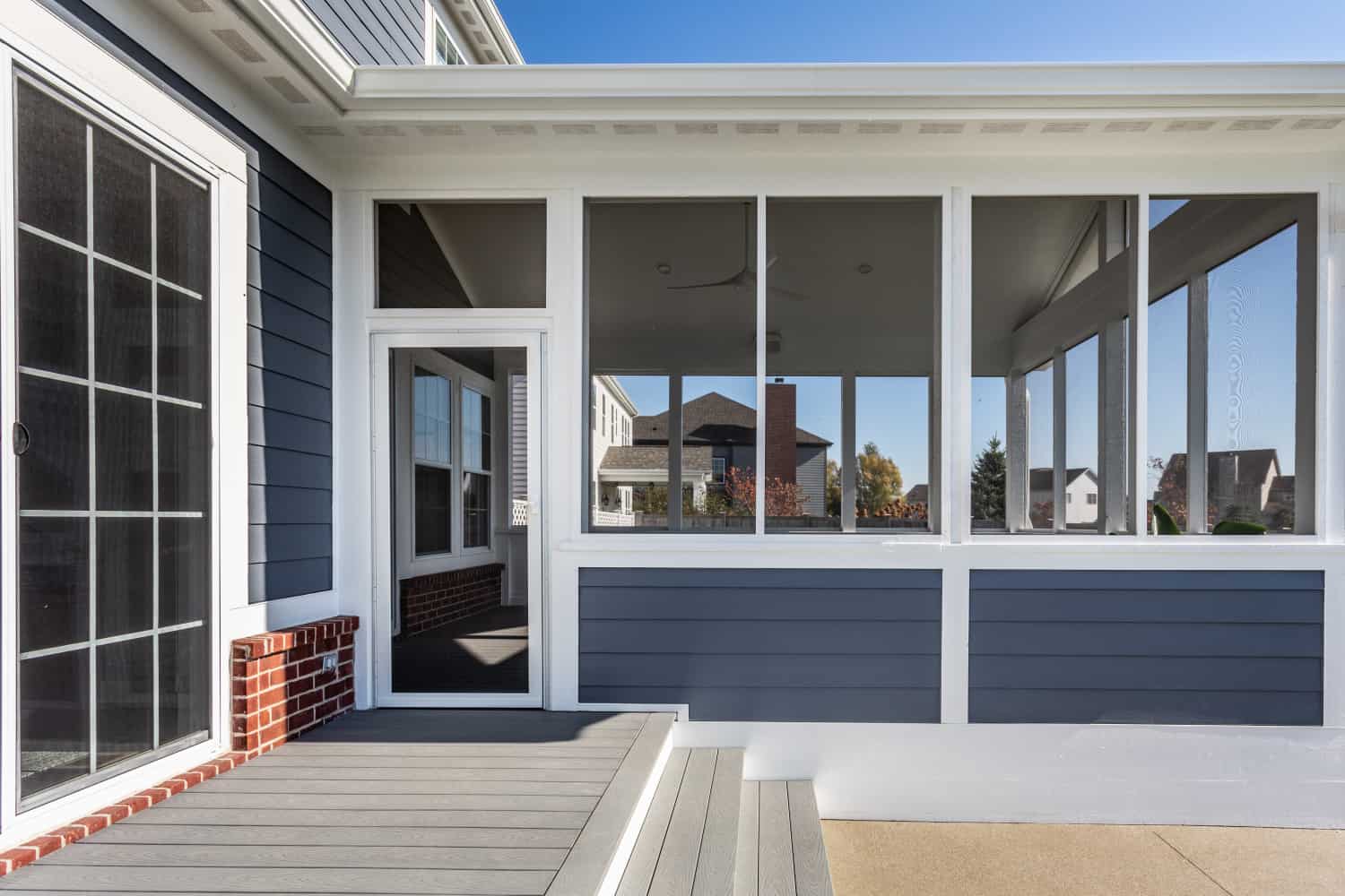 Nicholas Design Build | Remodel a screened-in porch with blue siding and white trim.