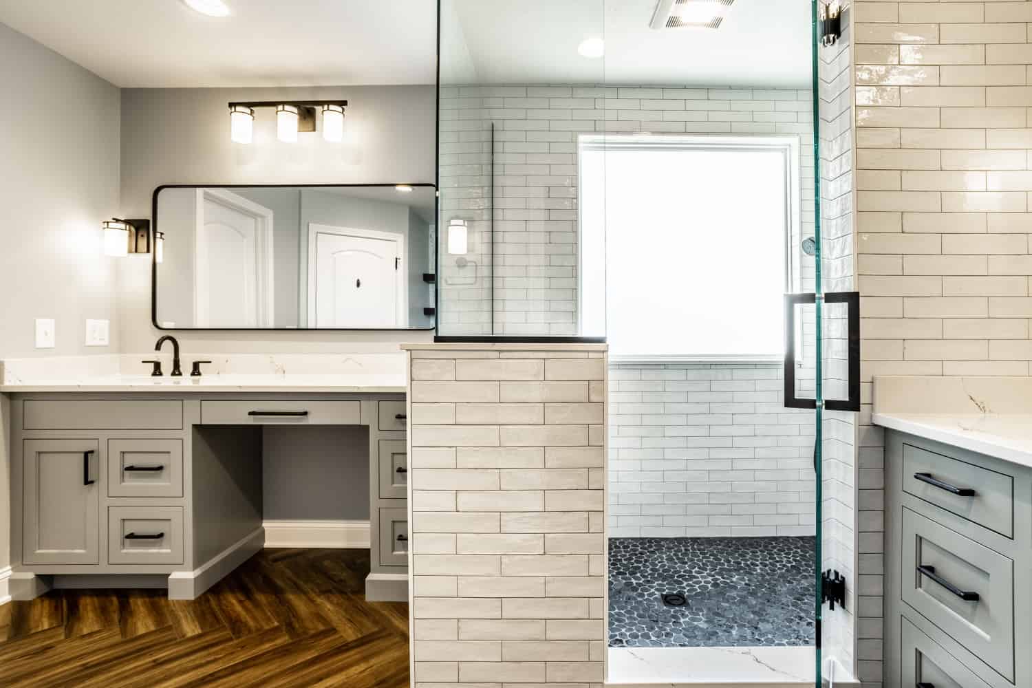 Nicholas Design Build | A black and blue bathroom with a glass shower stall and wood floors.