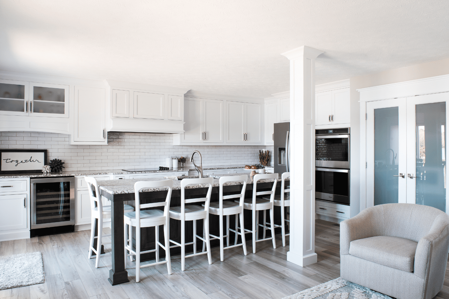 Nicholas Design Build | A white kitchen with wooden floors.