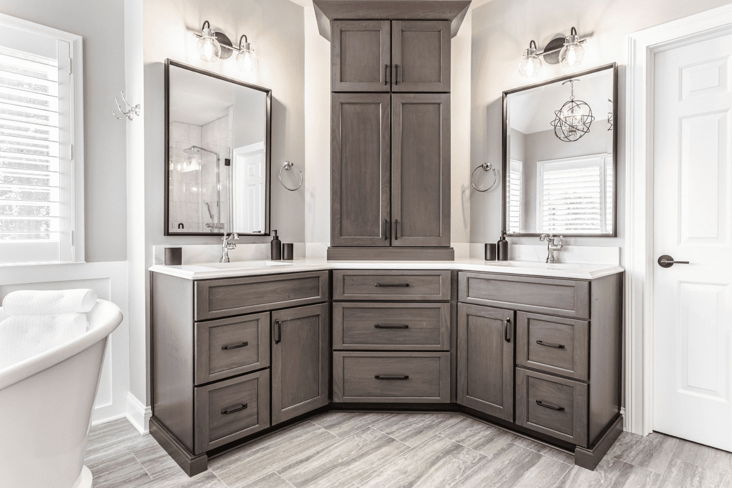 Nicholas Design Build |         A master bath remodel featuring gray cabinets and a bathtub.