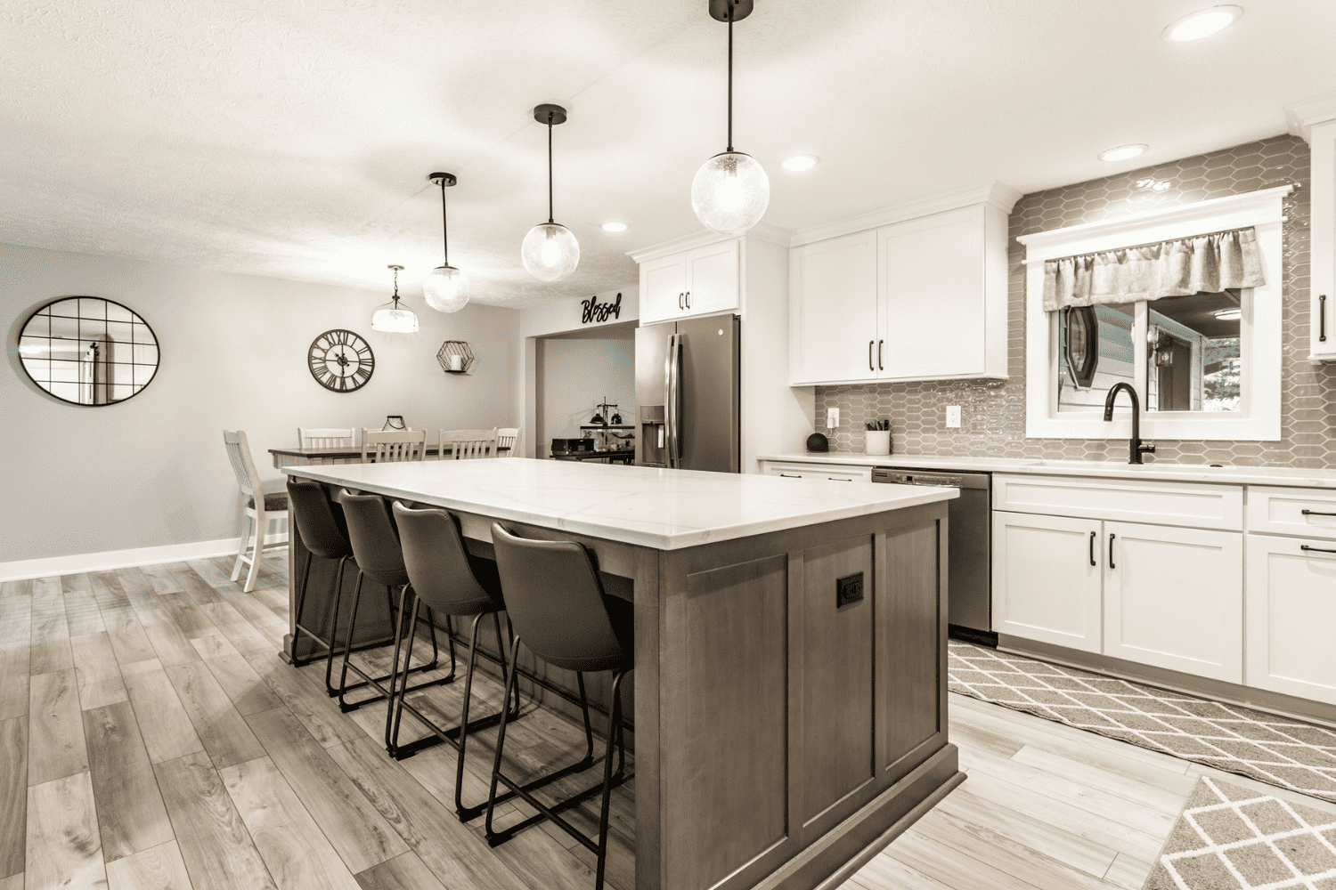 Nicholas Design Build | A neutral kitchen with a center island and bar stools.