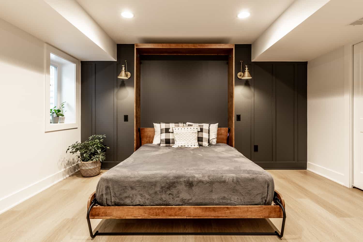 Nicholas Design Build | A remodelled bedroom with a bed in the middle of the room.