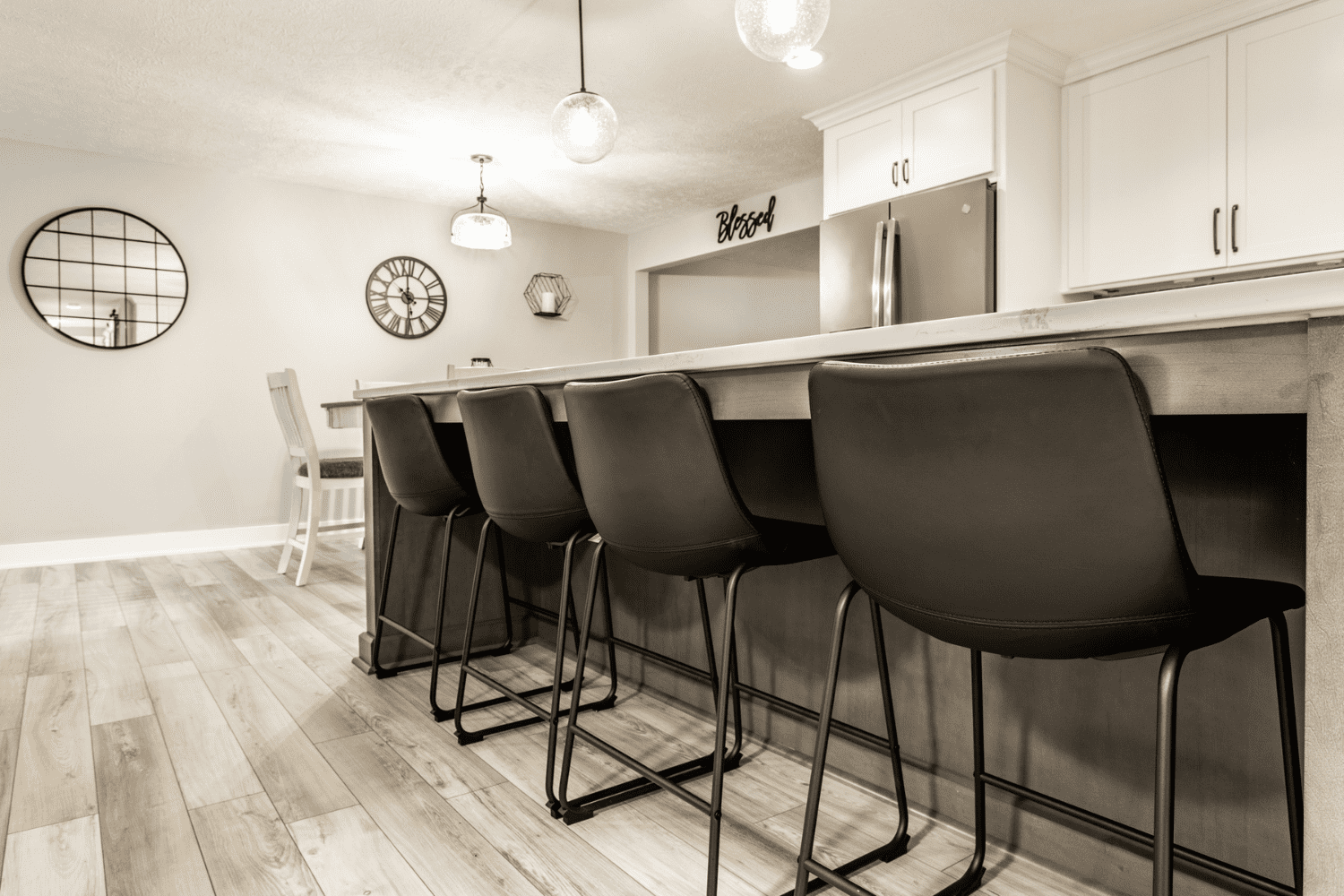 Nicholas Design Build | A neutral kitchen with black stools.