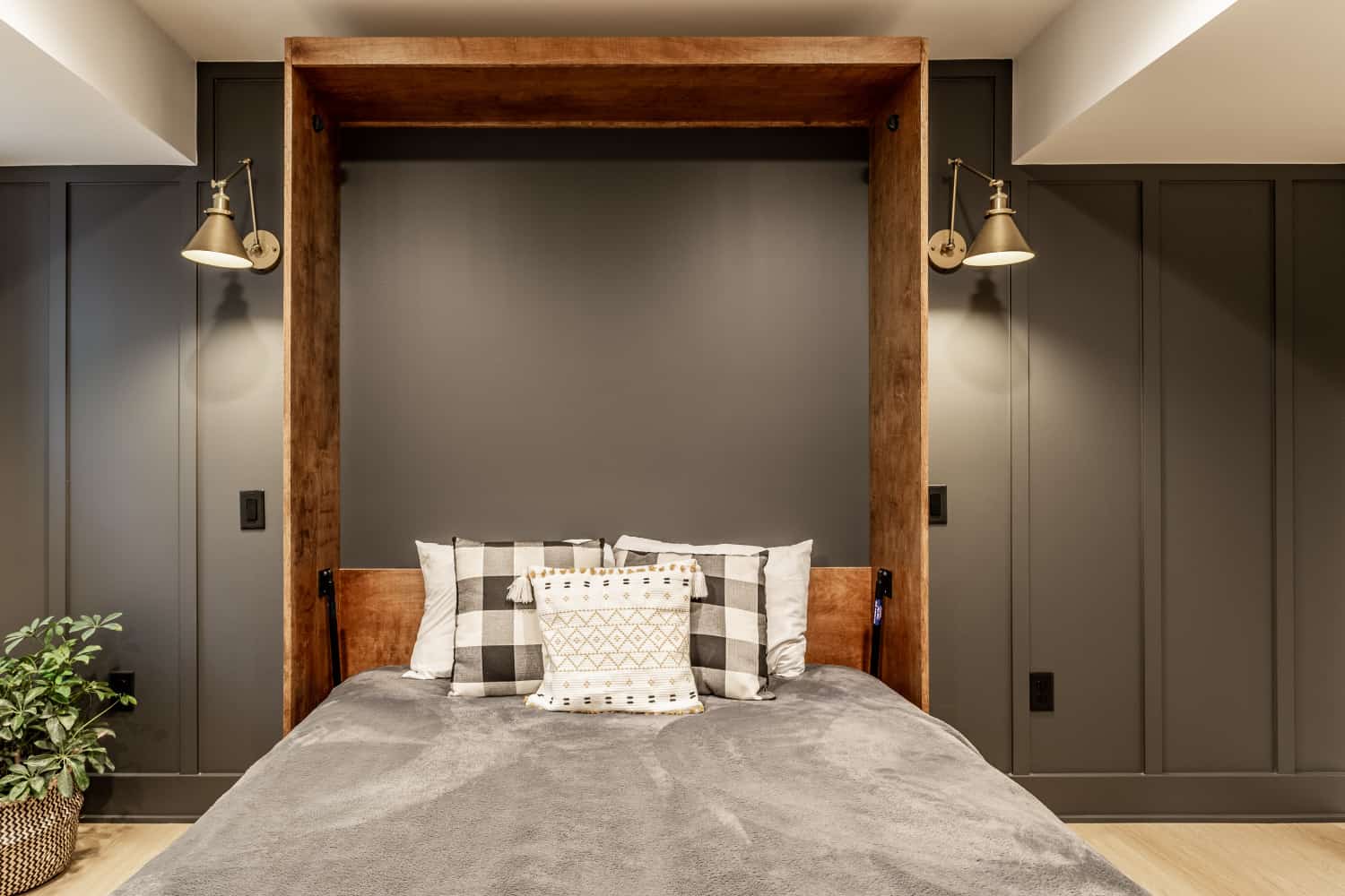 Nicholas Design Build | A bedroom with a bed and a wooden headboard underwent a remodel.