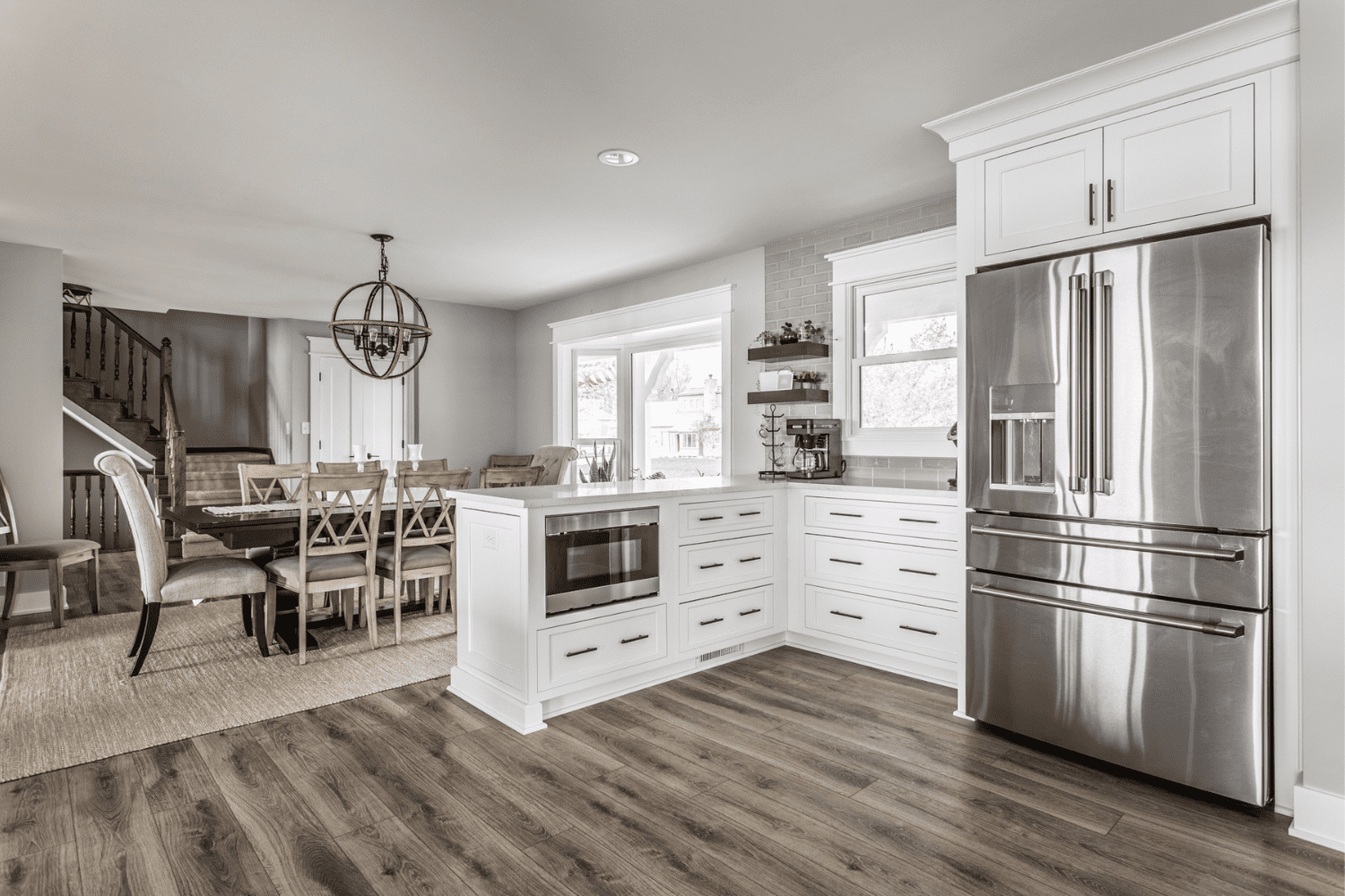 Nicholas Design Build | A kitchen with hardwood floors and stainless steel appliances.