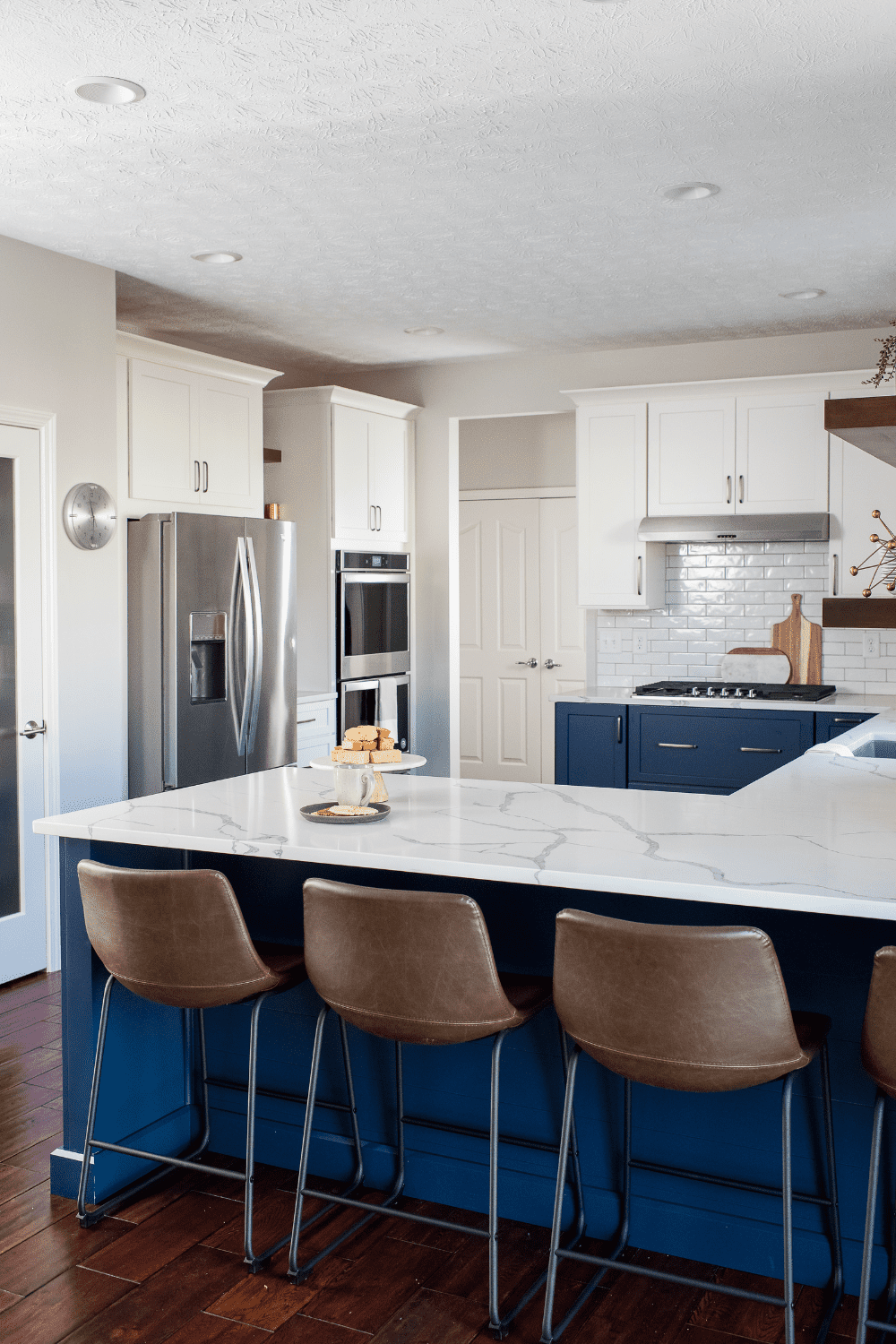 Nicholas Design Build | A kitchen with blue cabinets and a center island.