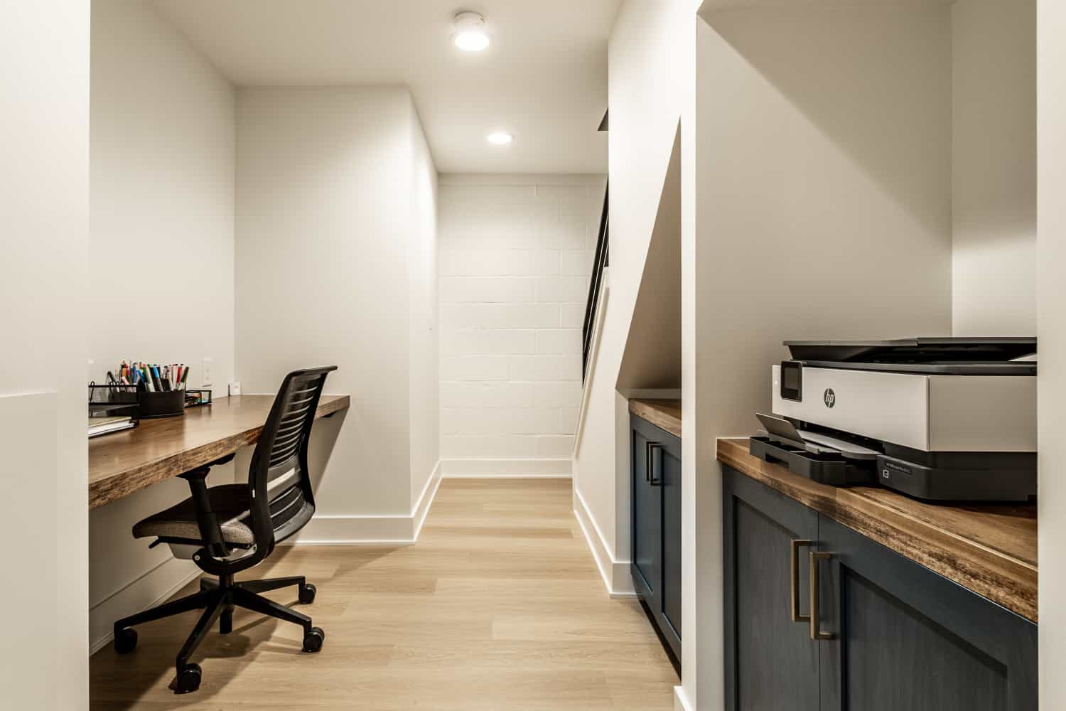 Nicholas Design Build | Remodel a home office with a desk and a printer.