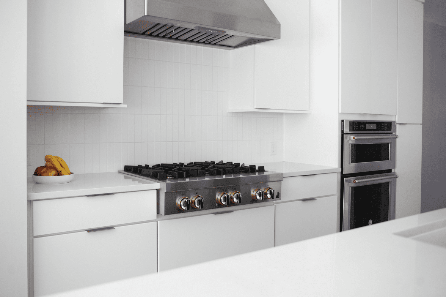 Nicholas Design Build | A white kitchen with a stove and oven.