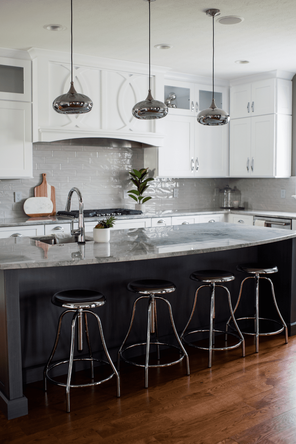 Nicholas Design Build | A kitchen with a center island and stools.