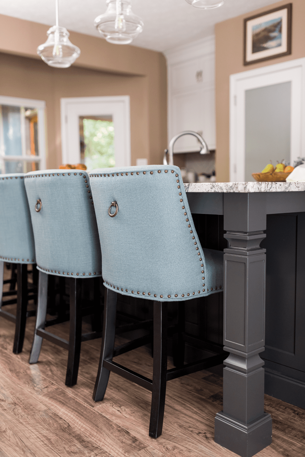 Nicholas Design Build | A versatile kitchen with blue upholstered bar stools.