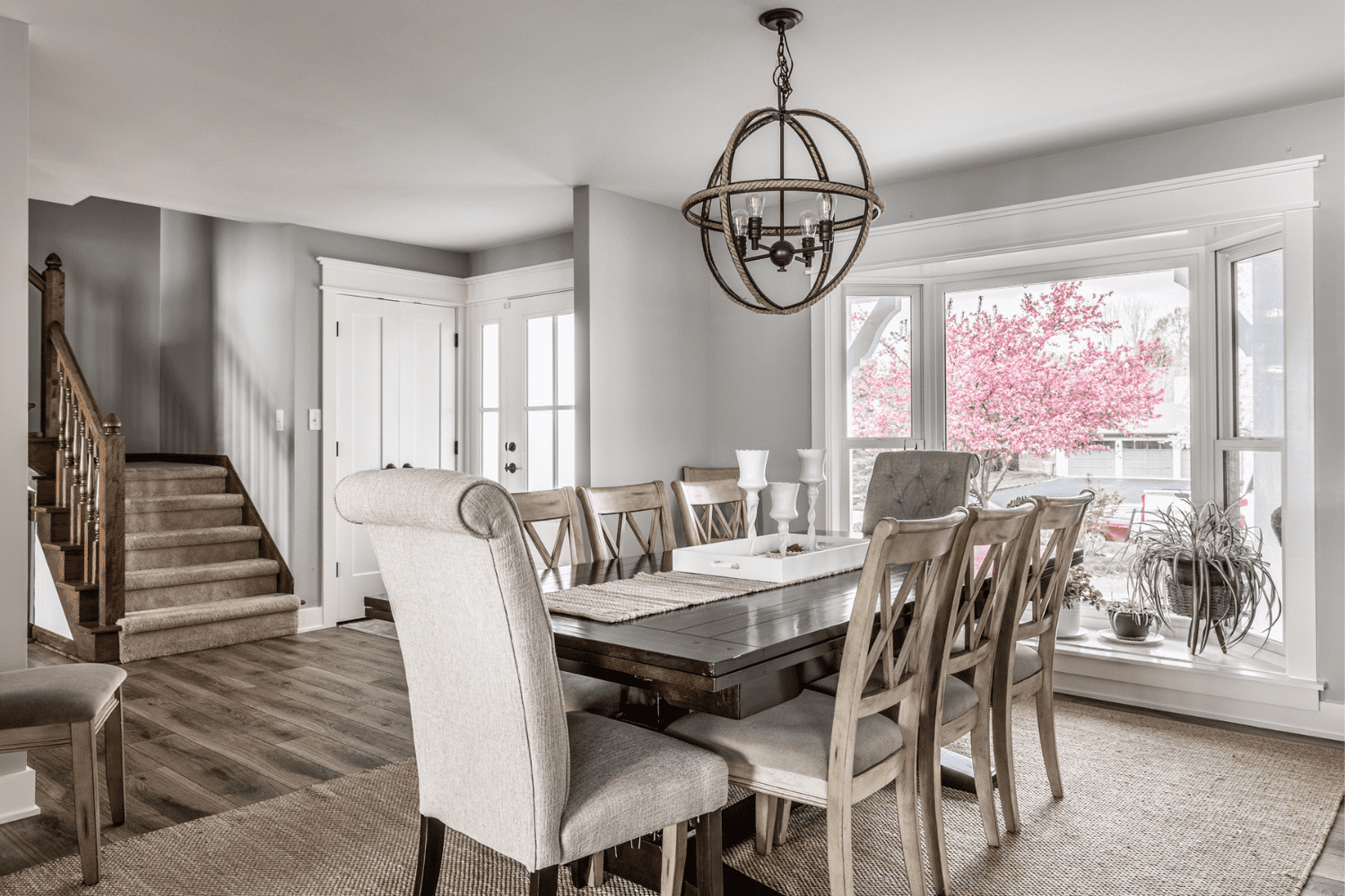 Nicholas Design Build | A dining room with a wooden table and chairs.