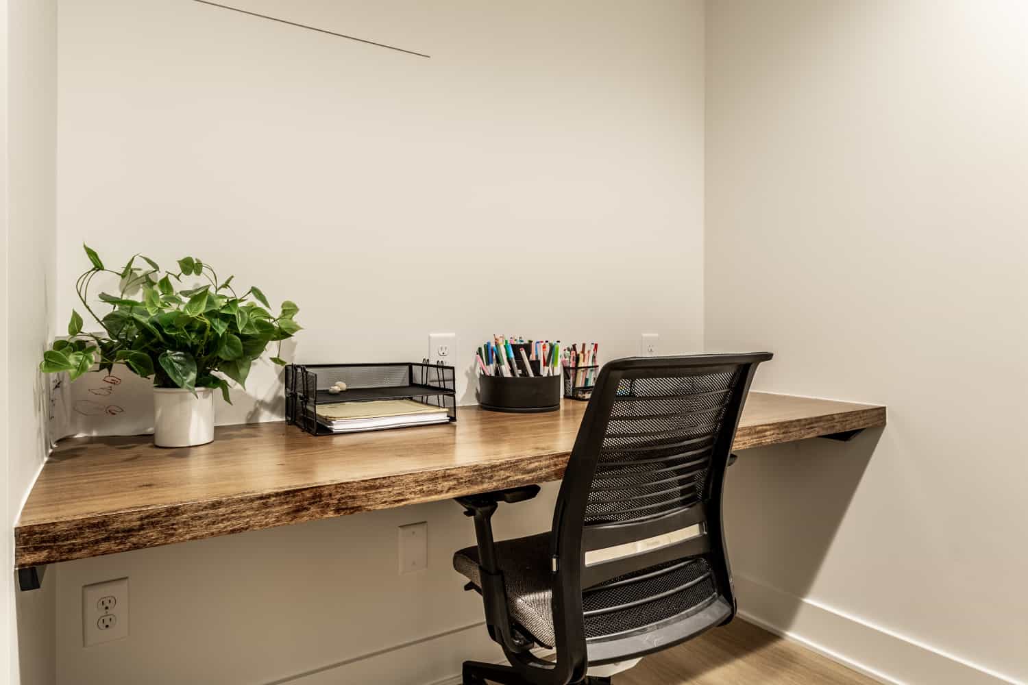 Nicholas Design Build | A small office undergoing a remodel with a desk and chair.