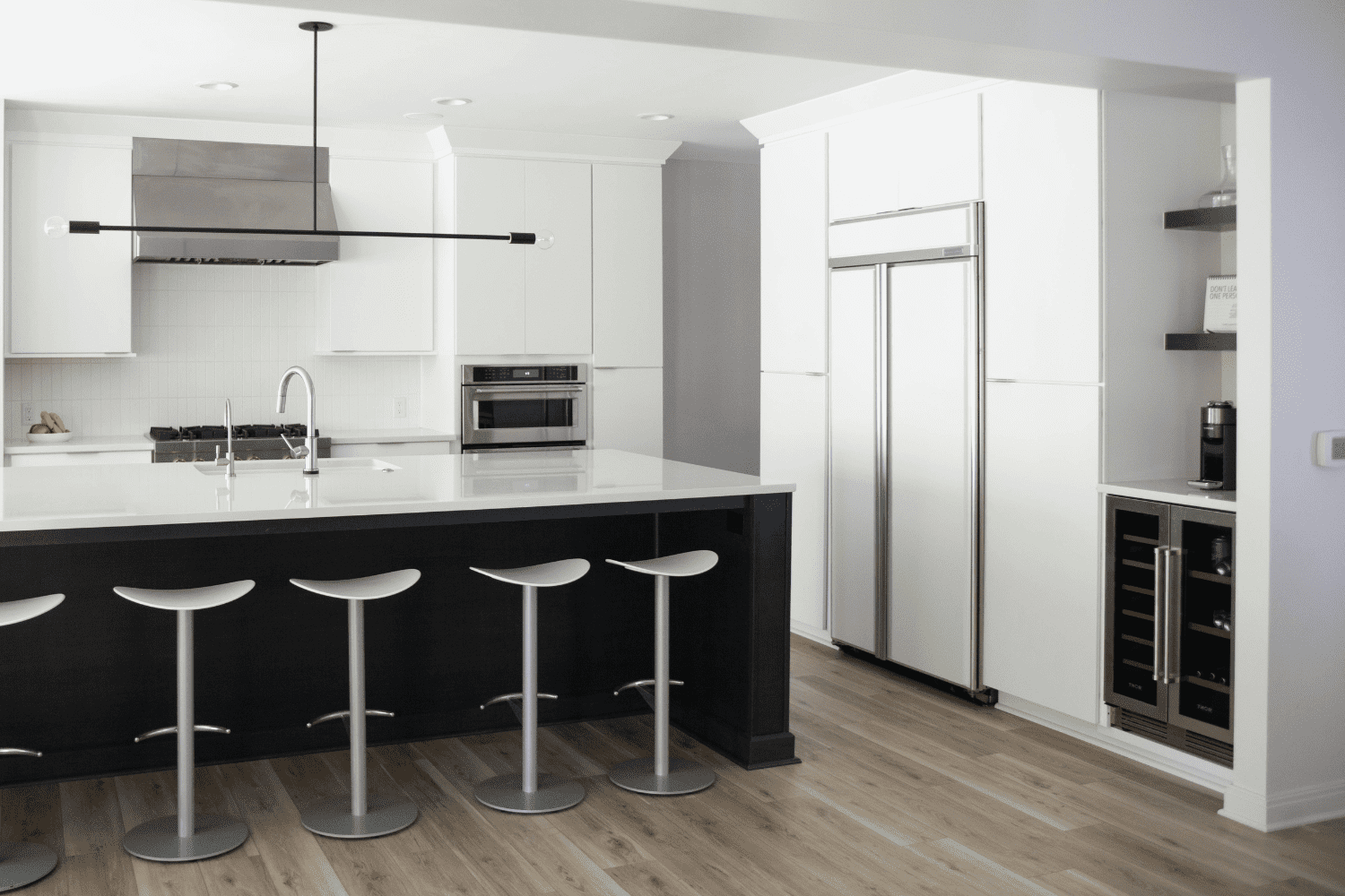 Nicholas Design Build | A black and white kitchen with stools.