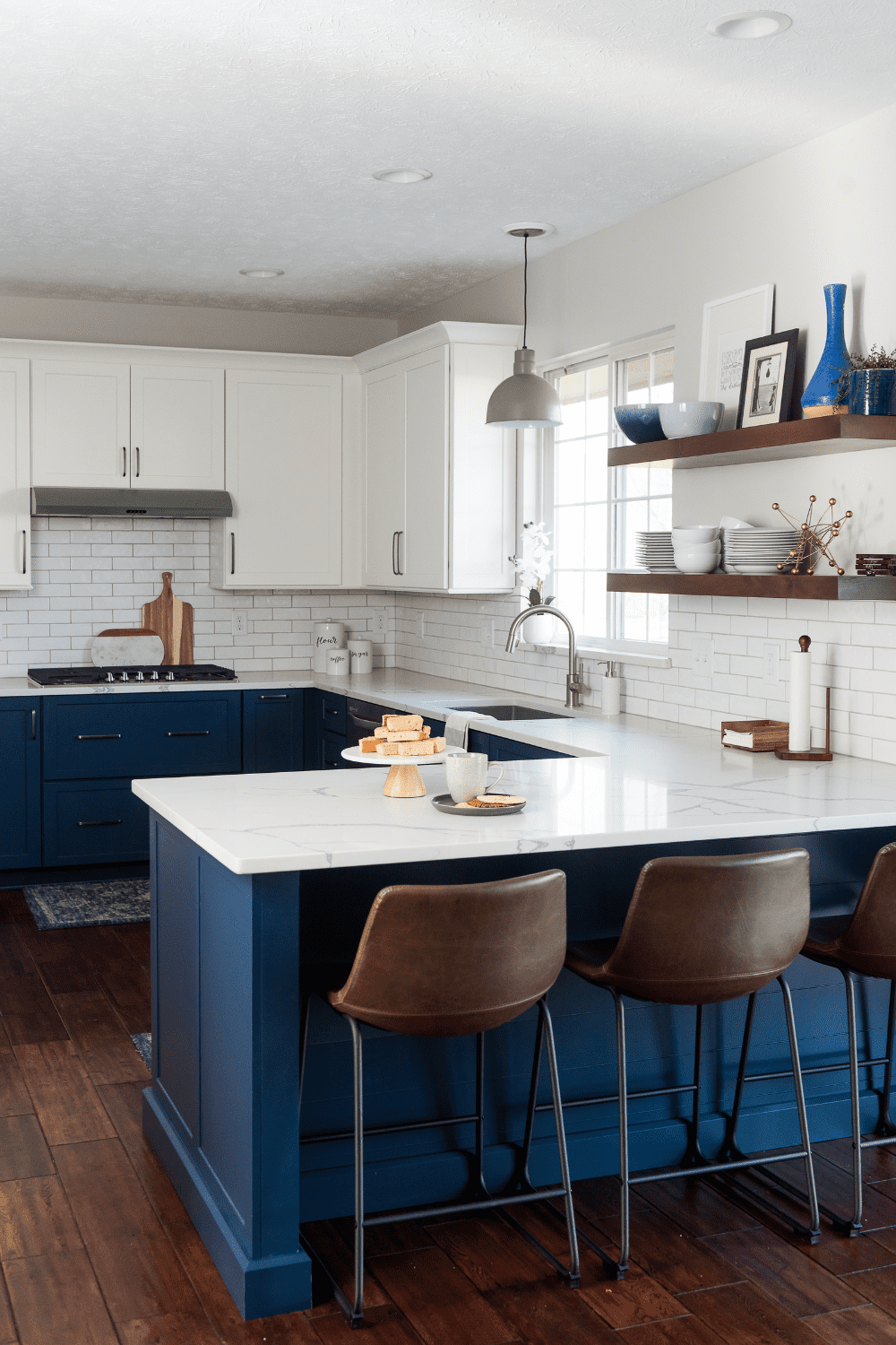 Nicholas Design Build | A blue and white kitchen with wooden floors.