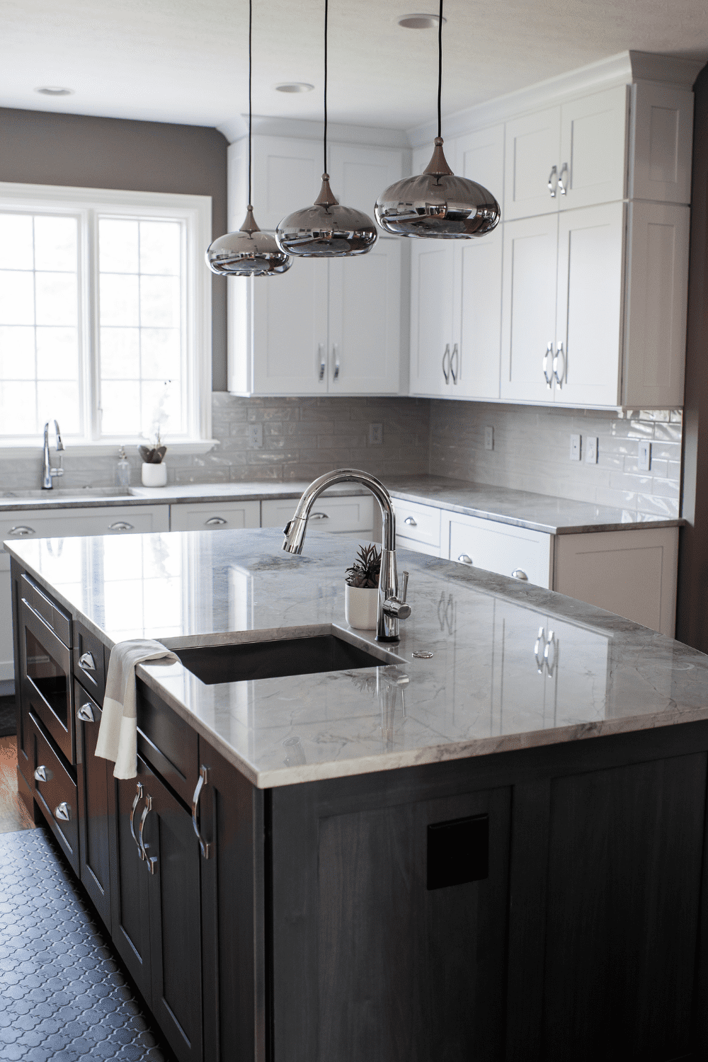Nicholas Design Build | A kitchen with a sink and counter tops.