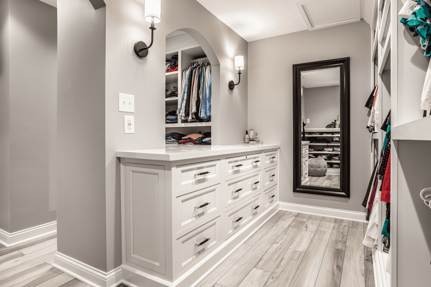 Nicholas Design Build | A walk in closet with a mirror and drawers.