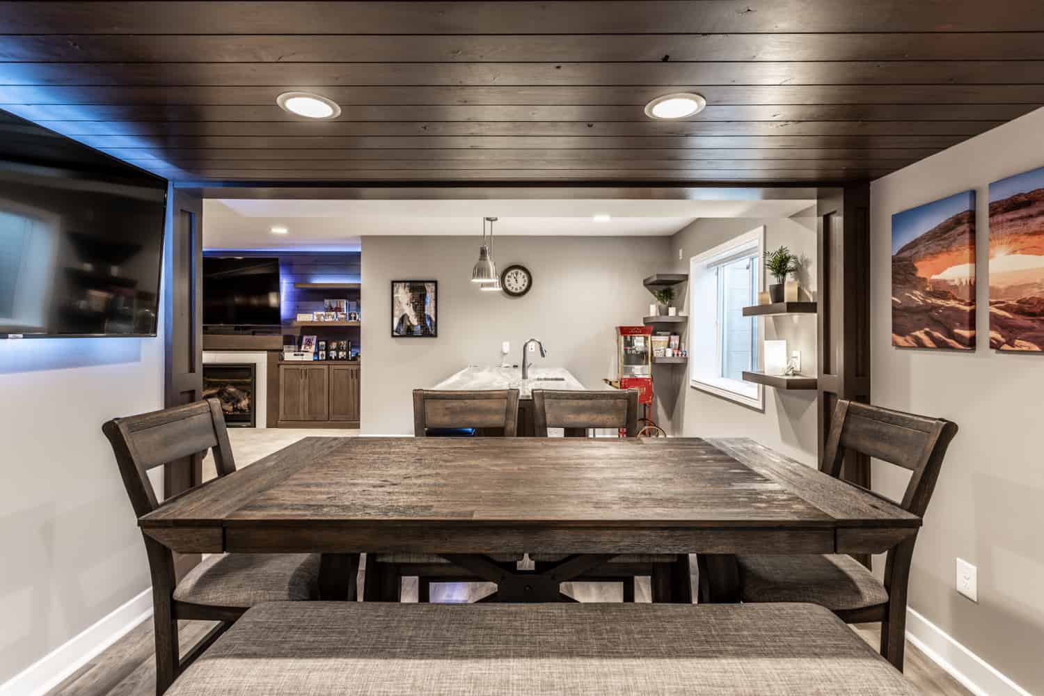 Nicholas Design Build | A remodeled dining room with a wooden table and chairs.