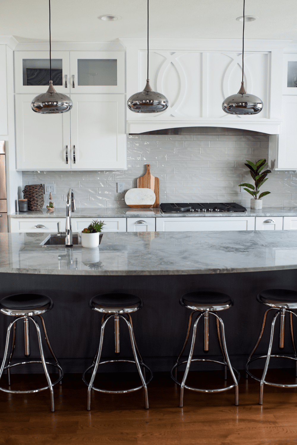 Nicholas Design Build | A white kitchen with black stools.