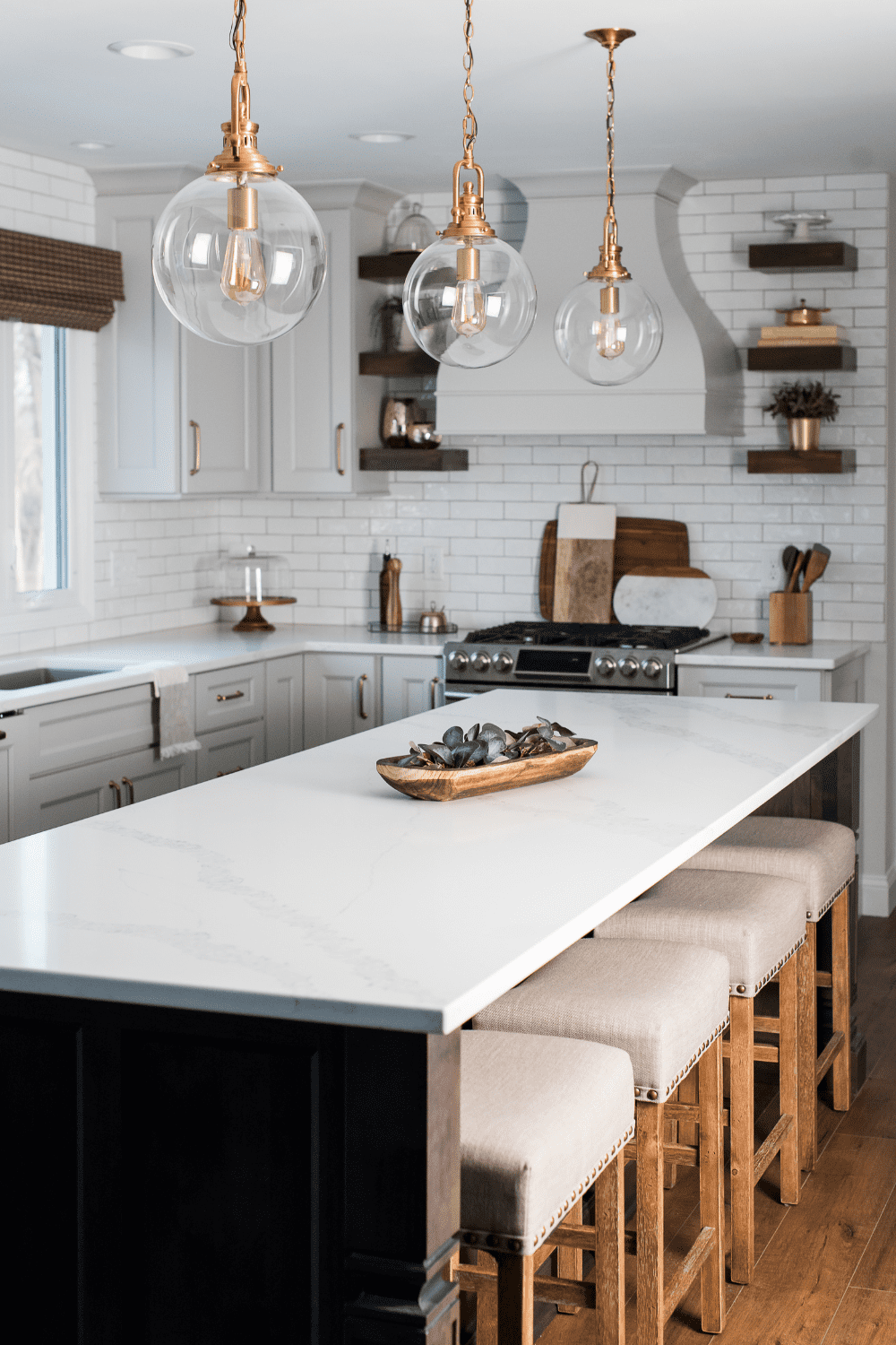 Nicholas Design Build | A neutral kitchen with a large island and stools.