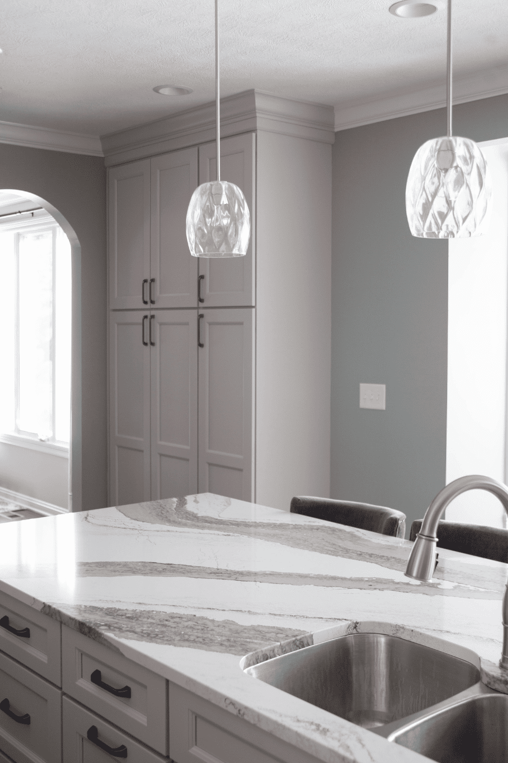 Nicholas Design Build | A kitchen with marble counter tops and a sink.