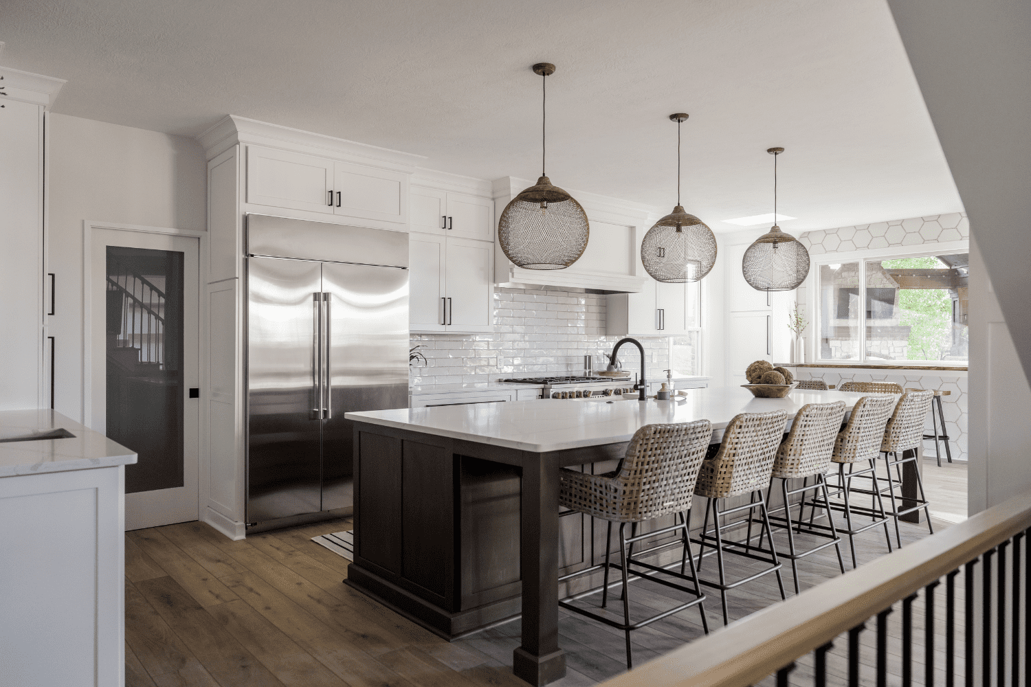 Nicholas Design Build | A kitchen with a large island and bar stools.