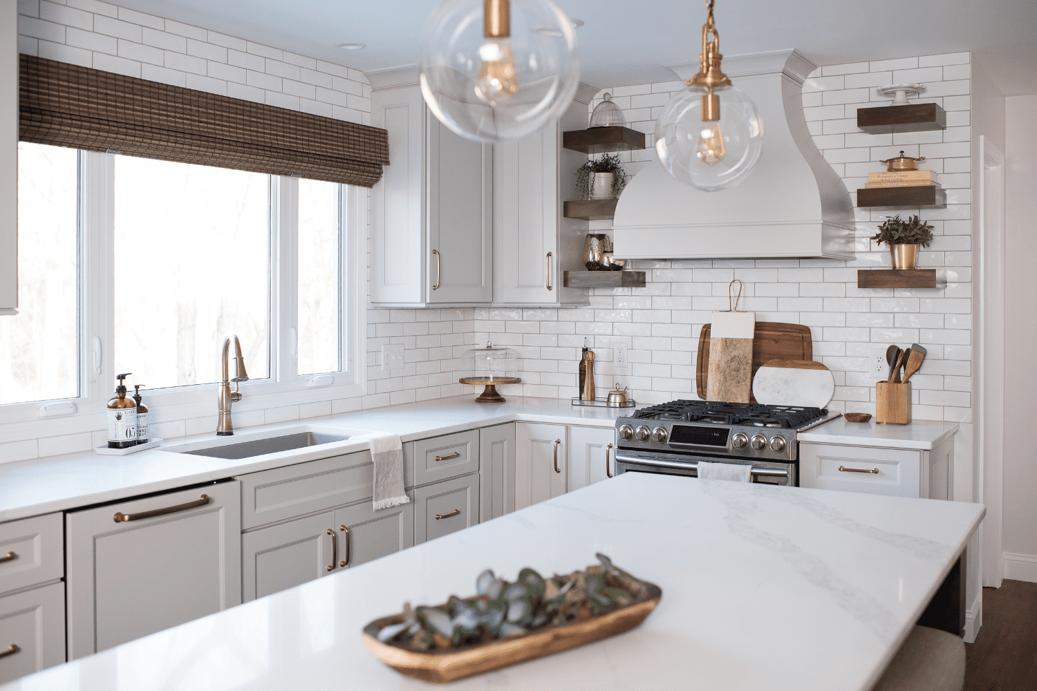 Nicholas Design Build | A neutral kitchen with white cabinets and gold accents.