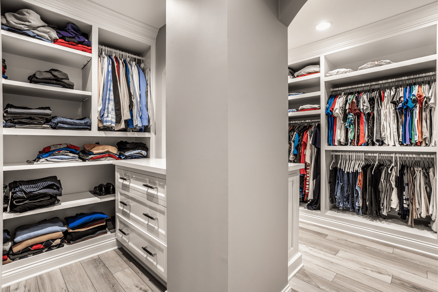 Nicholas Design Build | A walk in closet with a lot of clothes.