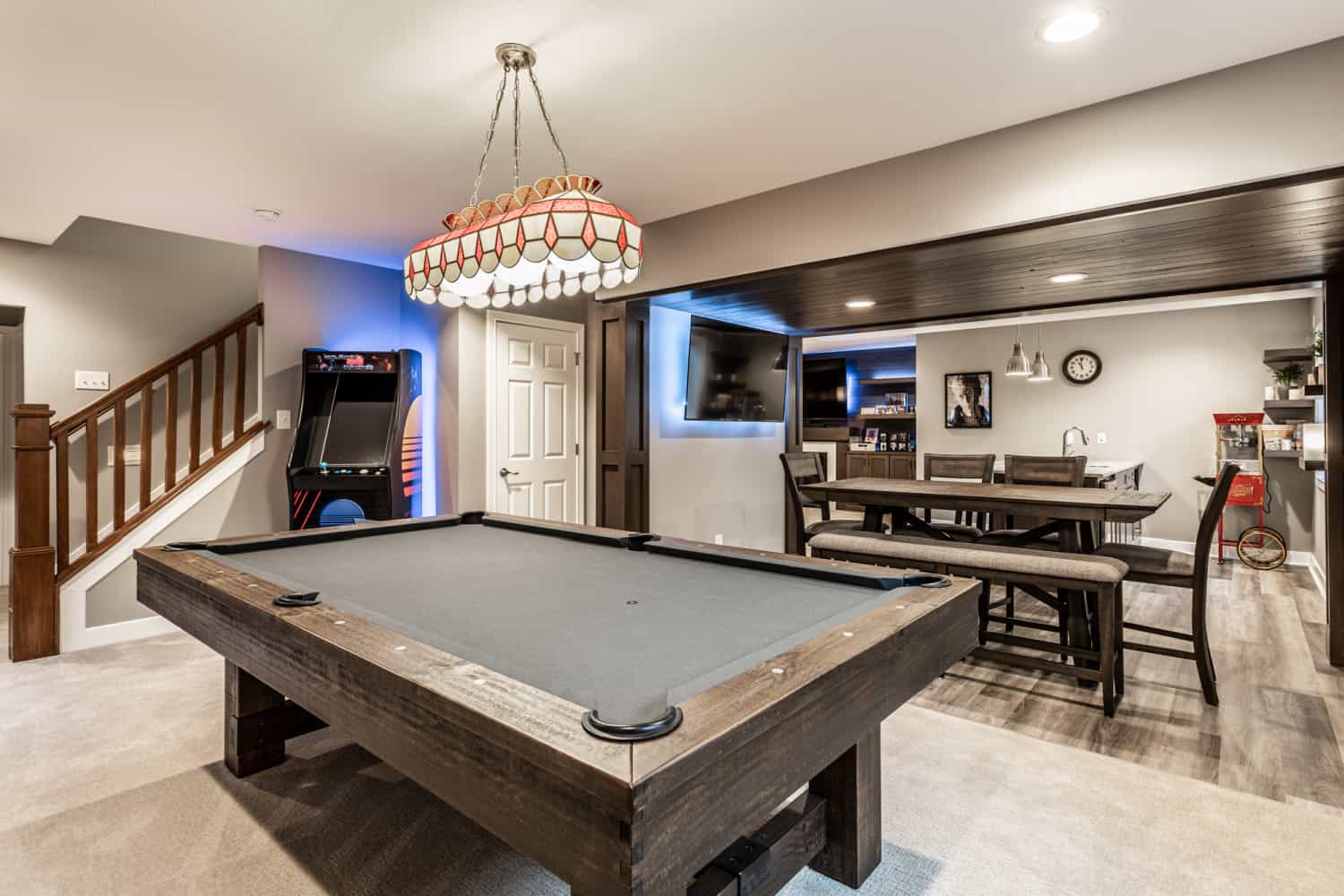 Nicholas Design Build | Remodeling a basement with both a pool table and a bar.
