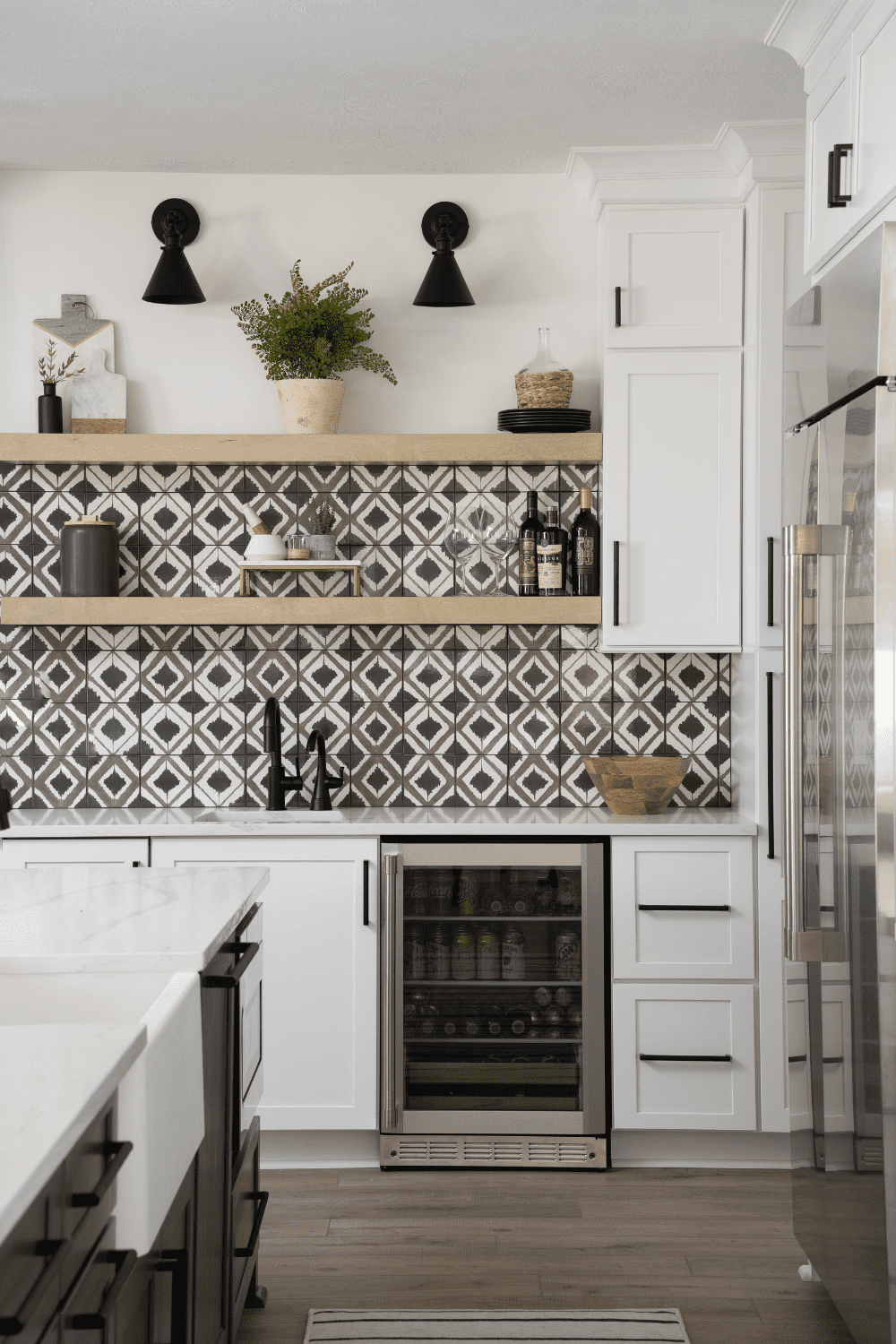 Nicholas Design Build | A black and white kitchen with a tile backsplash.
