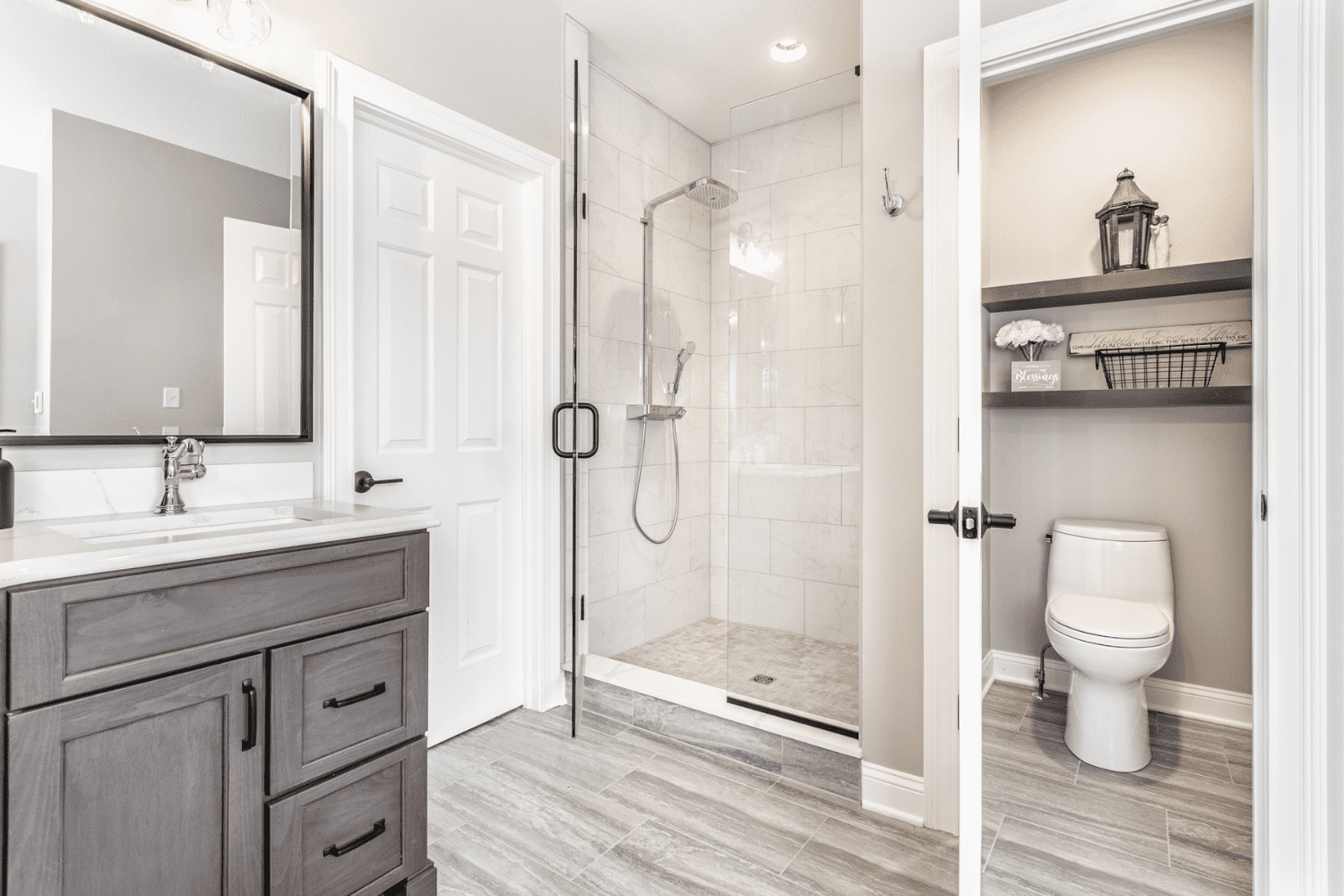 Nicholas Design Build | A renovated master bath with a walk-in shower and a toilet.