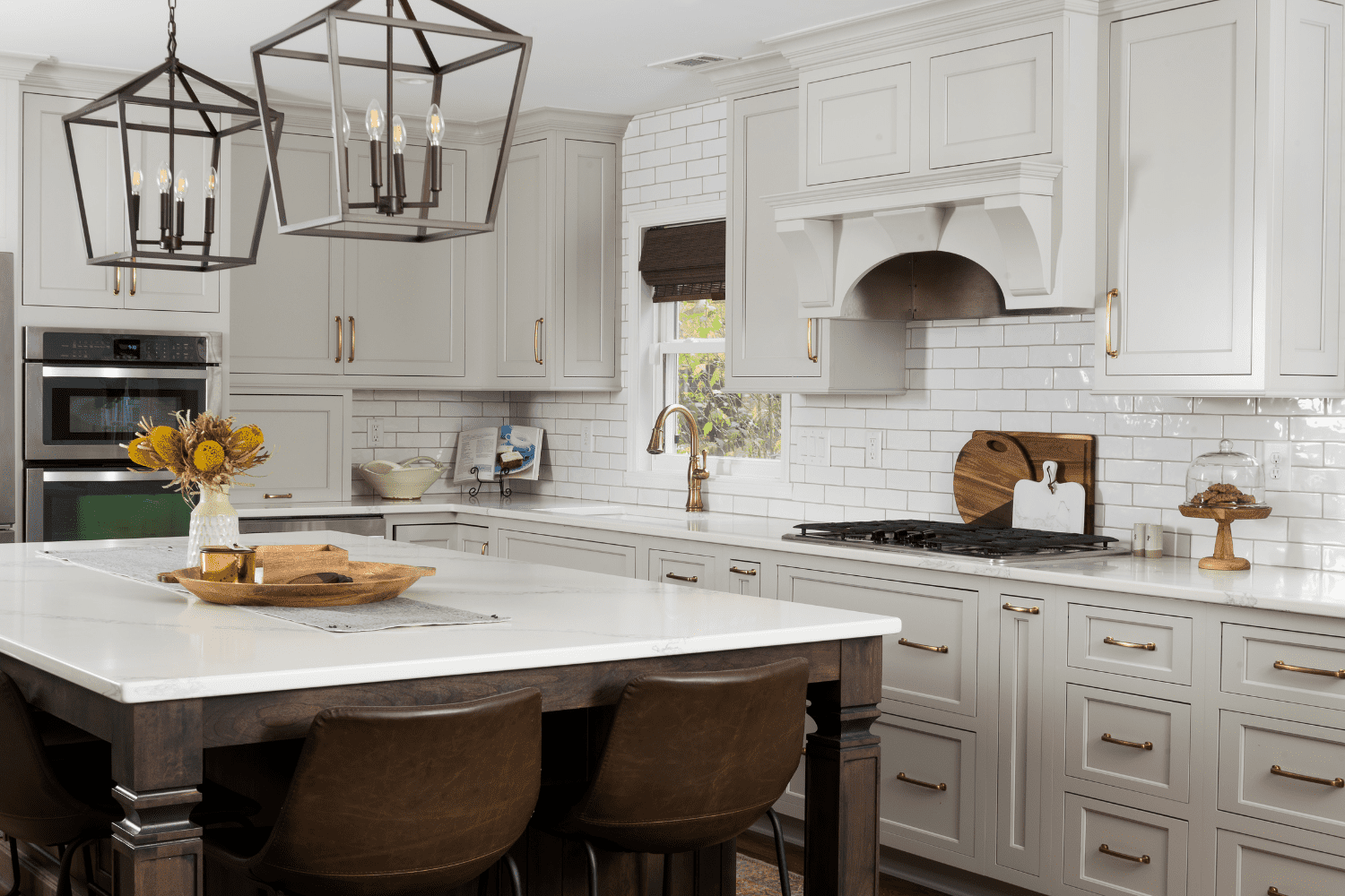 Nicholas Design Build | A kitchen with white cabinets and a center island.