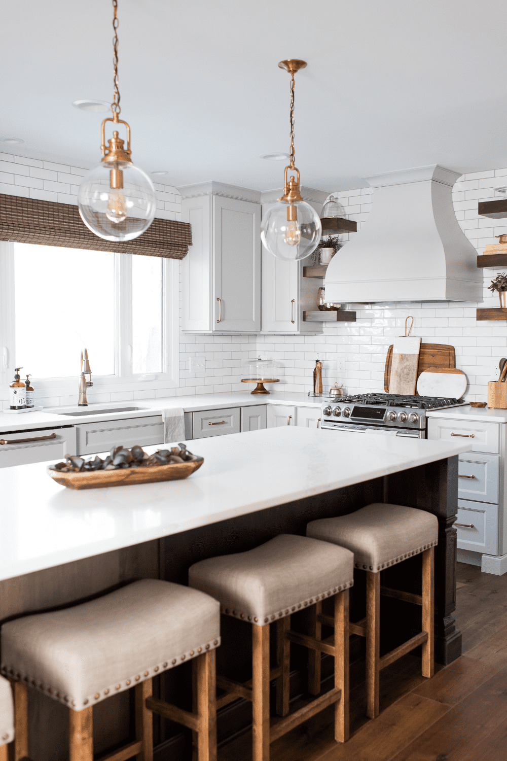 Nicholas Design Build | A neutral kitchen with a large island and stools.