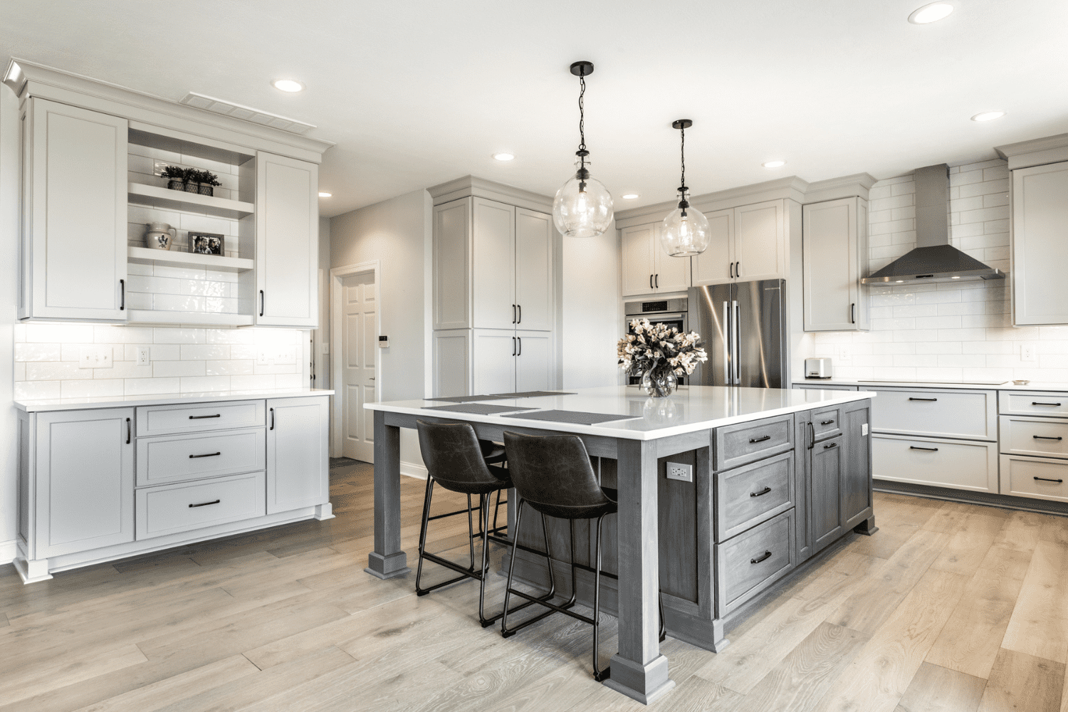 Nicholas Design Build | A kitchen with gray cabinets and a center island.