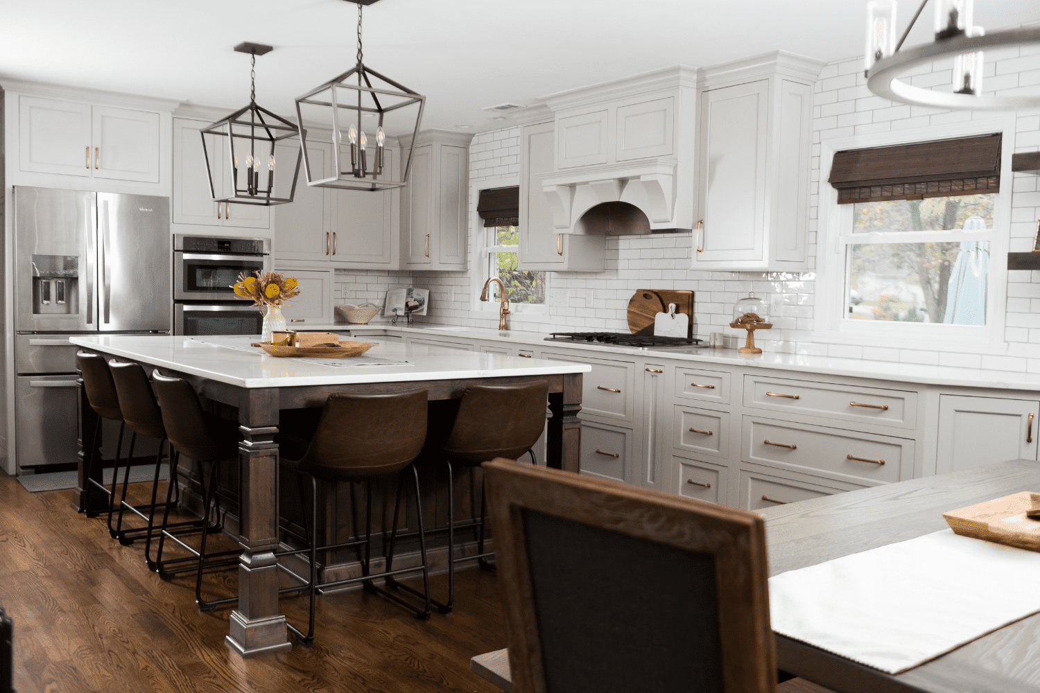 Nicholas Design Build | A kitchen with white cabinets and wood floors.