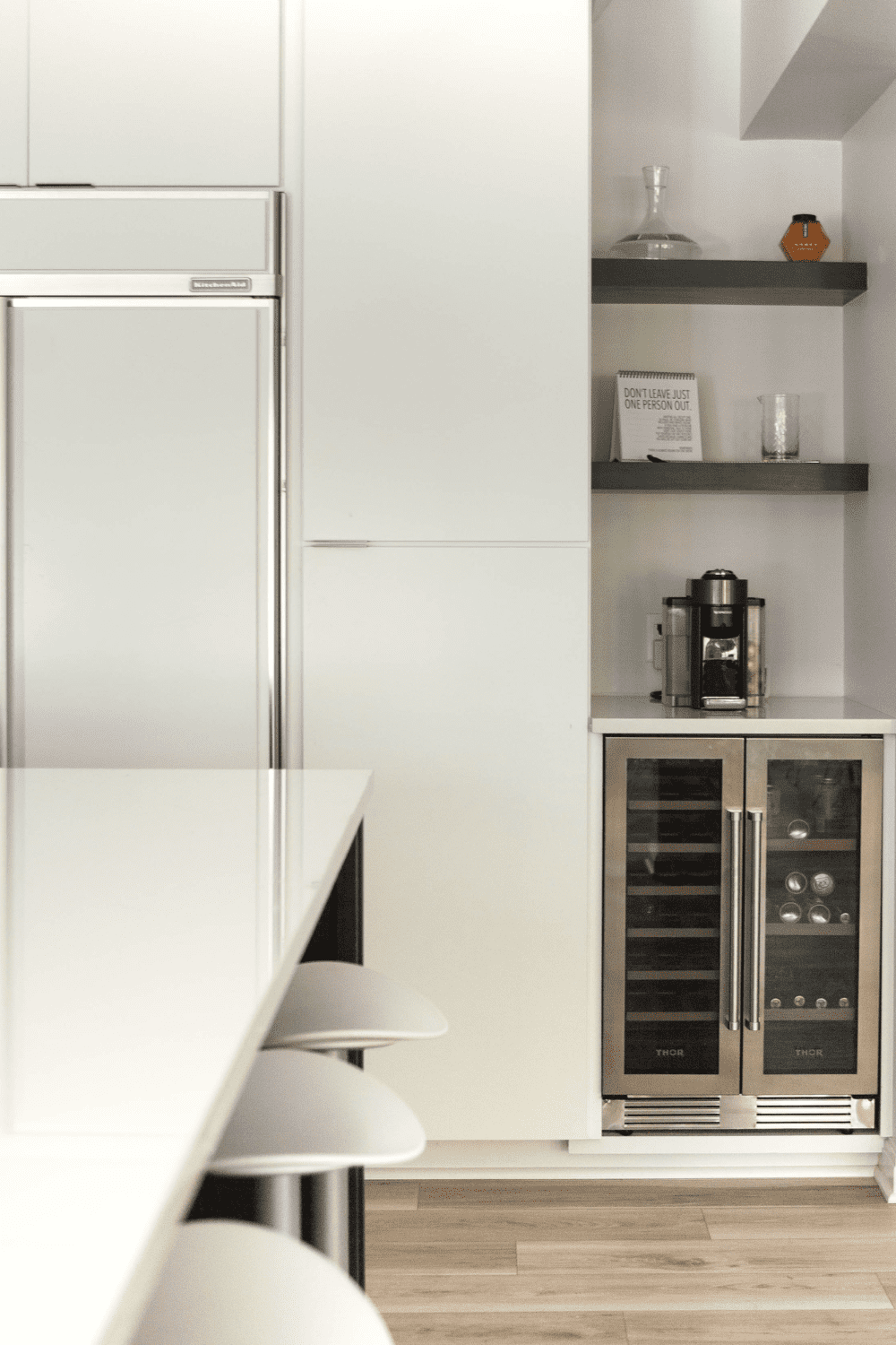 Nicholas Design Build | A white kitchen with a wine cooler.