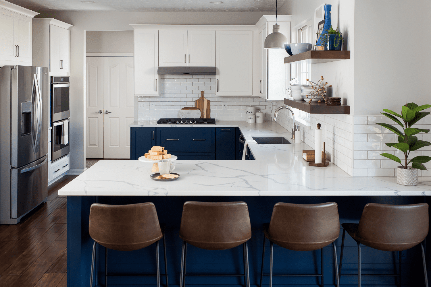 Nicholas Design Build | A blue and white kitchen with brown stools.