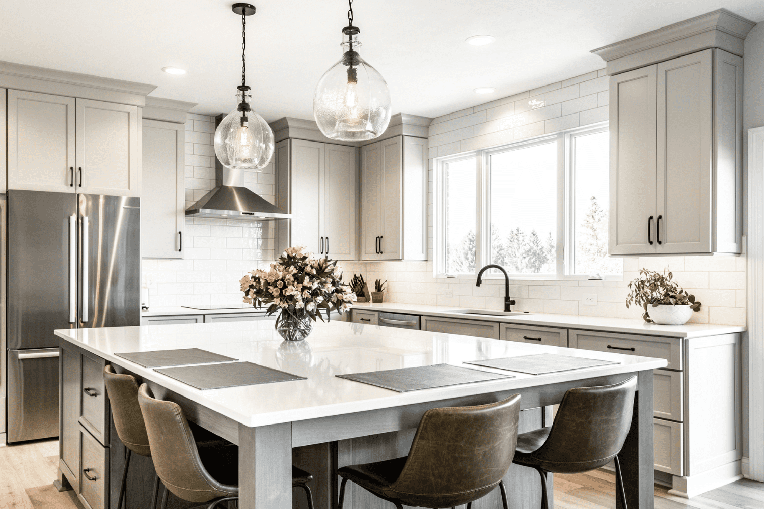 Nicholas Design Build | A kitchen with a large island and chairs.