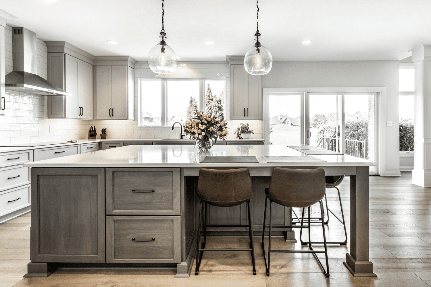 Nicholas Design Build | A kitchen with a center island and stools.