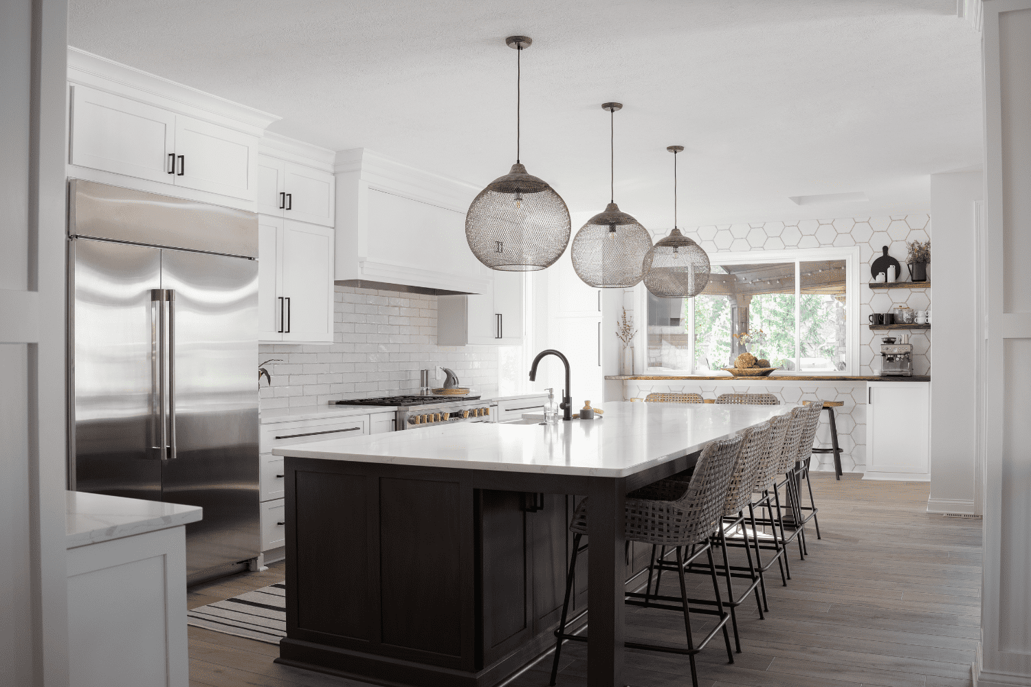 Nicholas Design Build | A kitchen with white cabinets and black counter tops.