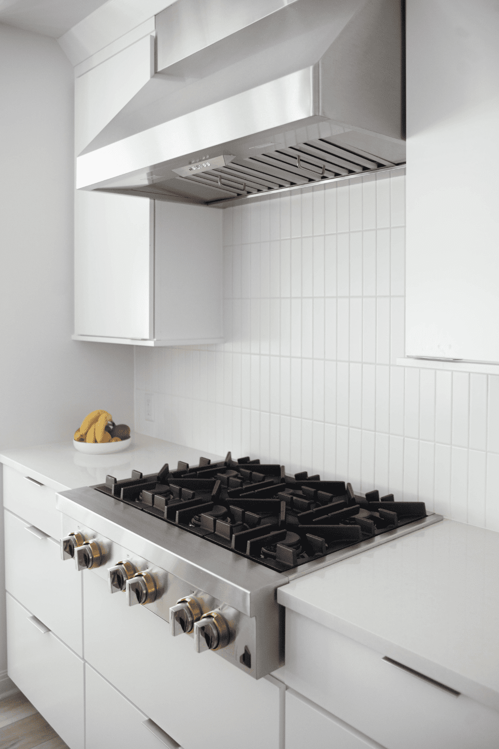 Nicholas Design Build | A white kitchen with a stove and oven.