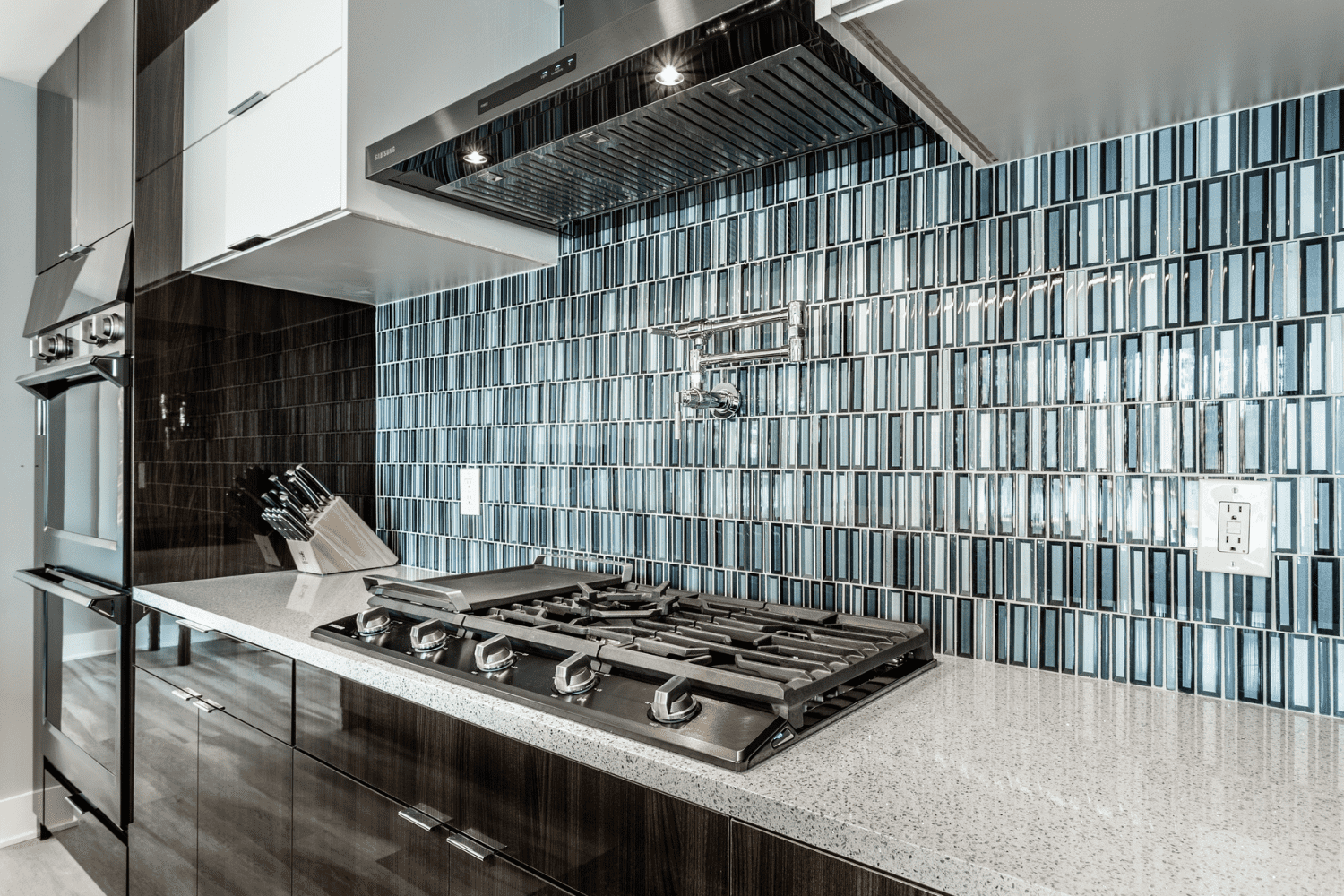 Nicholas Design Build | A blue tiled backsplash in a kitchen.