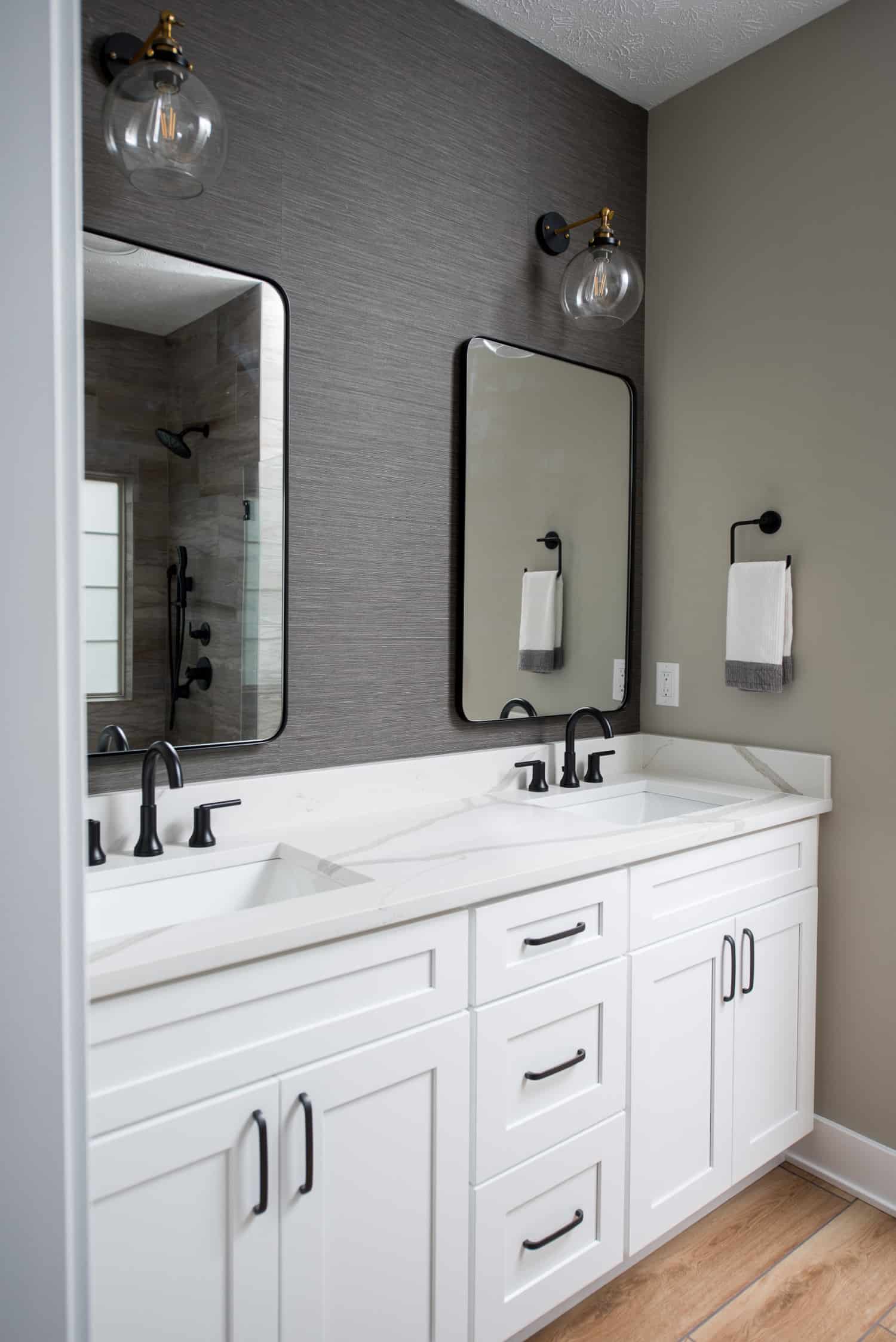 Nicholas Design Build | A modern bathroom with two sinks and a mirror.
