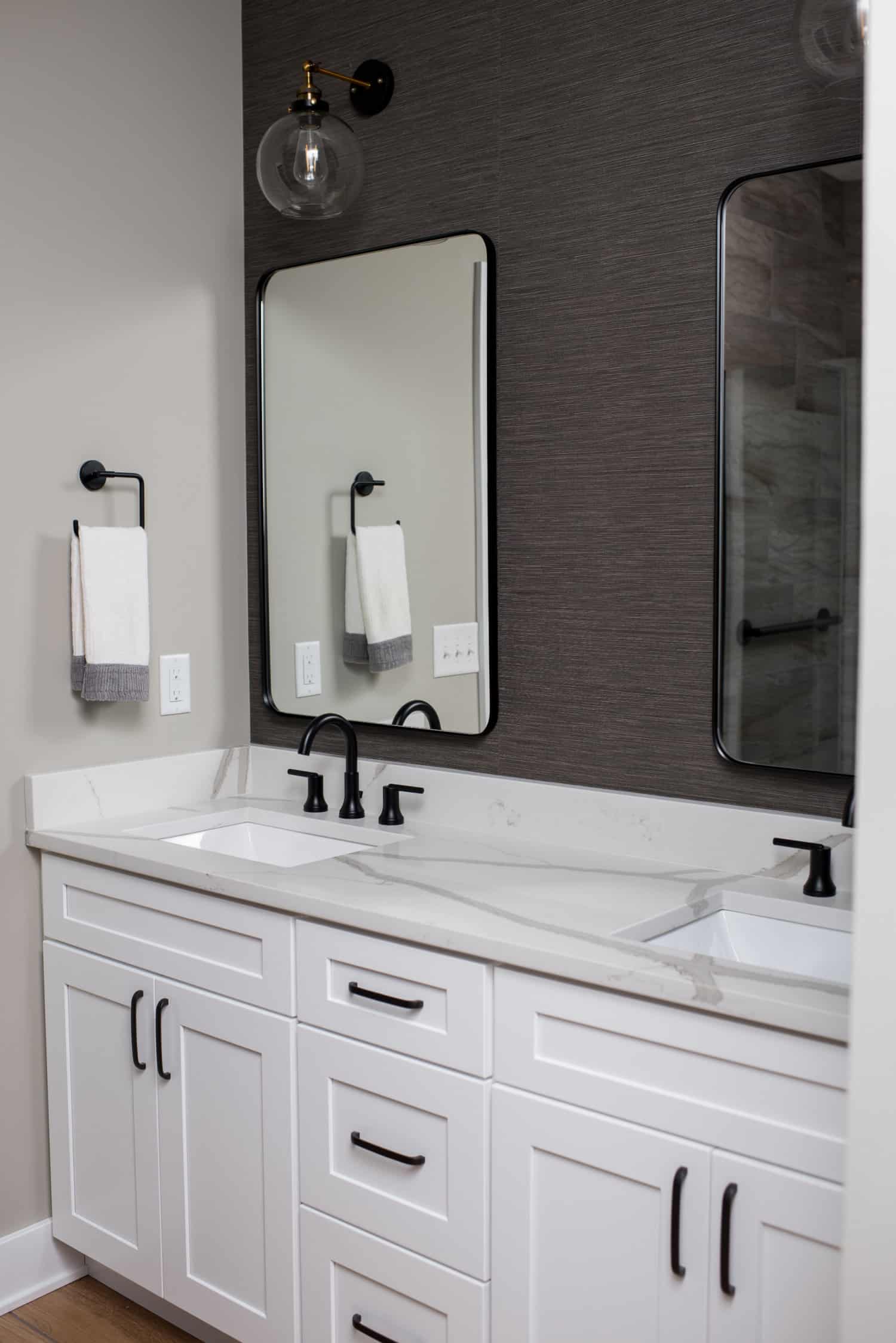 Nicholas Design Build | A modern bathroom with two sinks and a contemporary mirror.